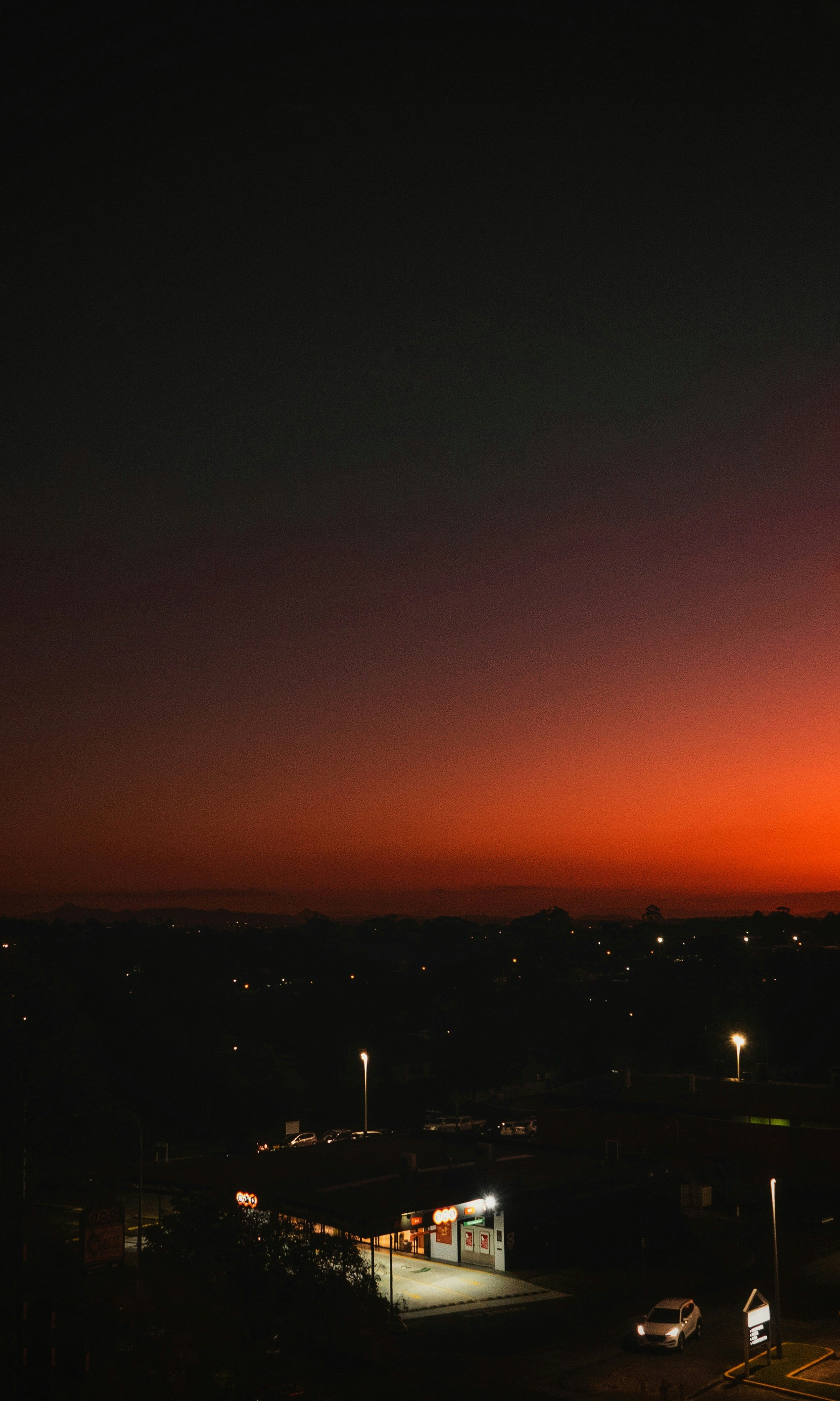 Pôr do sol sobre uma cidade com luzes.