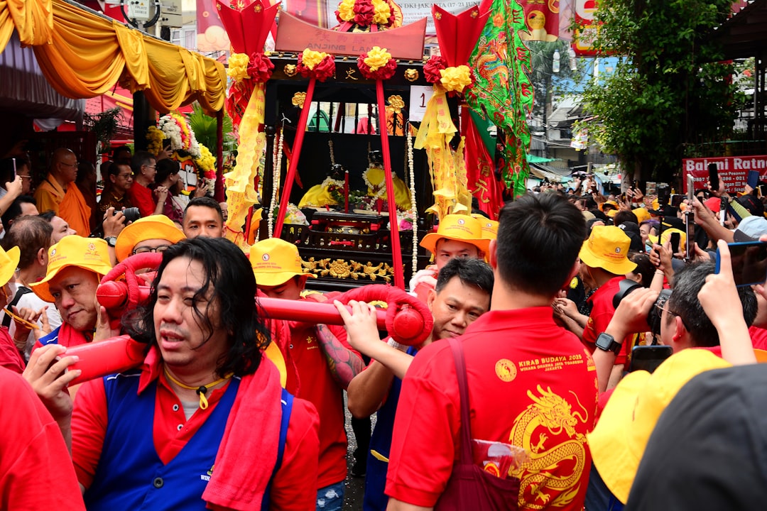 A chinese new year parade is shown., View of crowd from a cultural parade from Chinese culture, which held as celebration to 498 years of Jakarta Anniversary, in front of a temple in Jakarta, Indonesia, June 21, 2025.