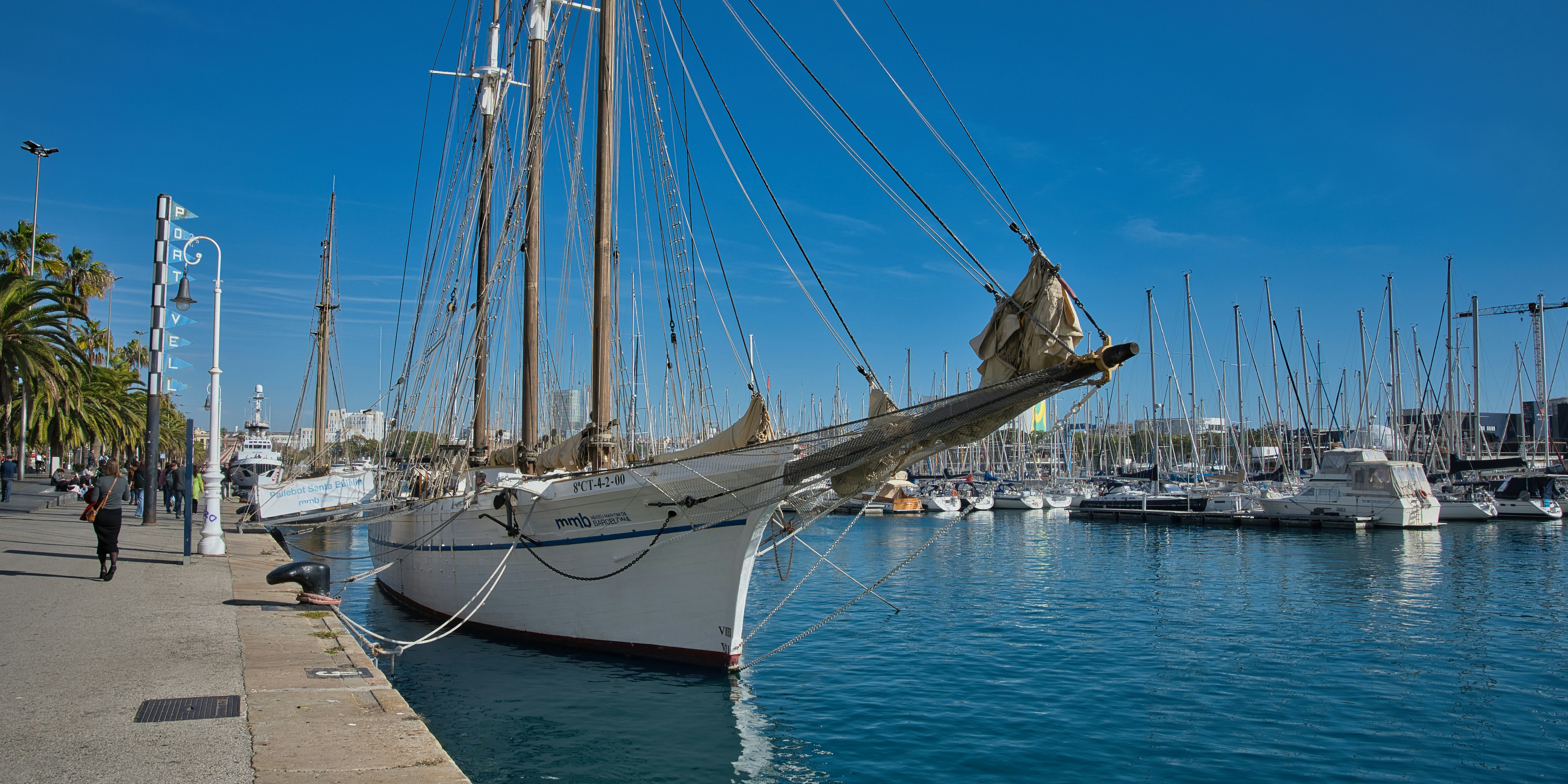 A sailboat docked at the harbor on a sunny day.