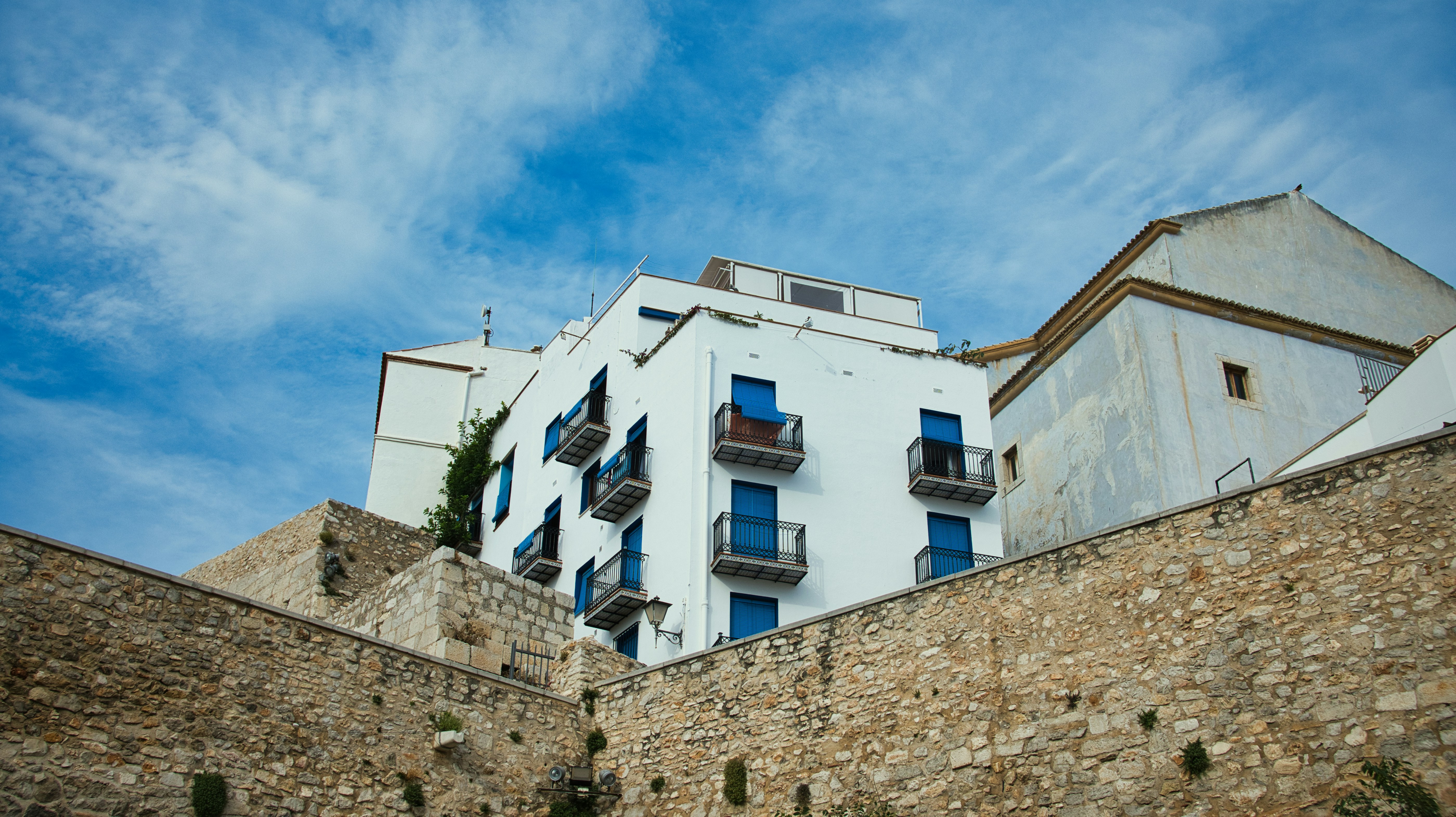 Buildings sit beneath a vibrant blue sky.