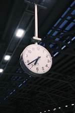 Clock hanging from a ceiling.