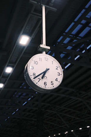 Clock hanging from a ceiling.