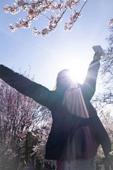 Woman holds paper up to bright sunlight.