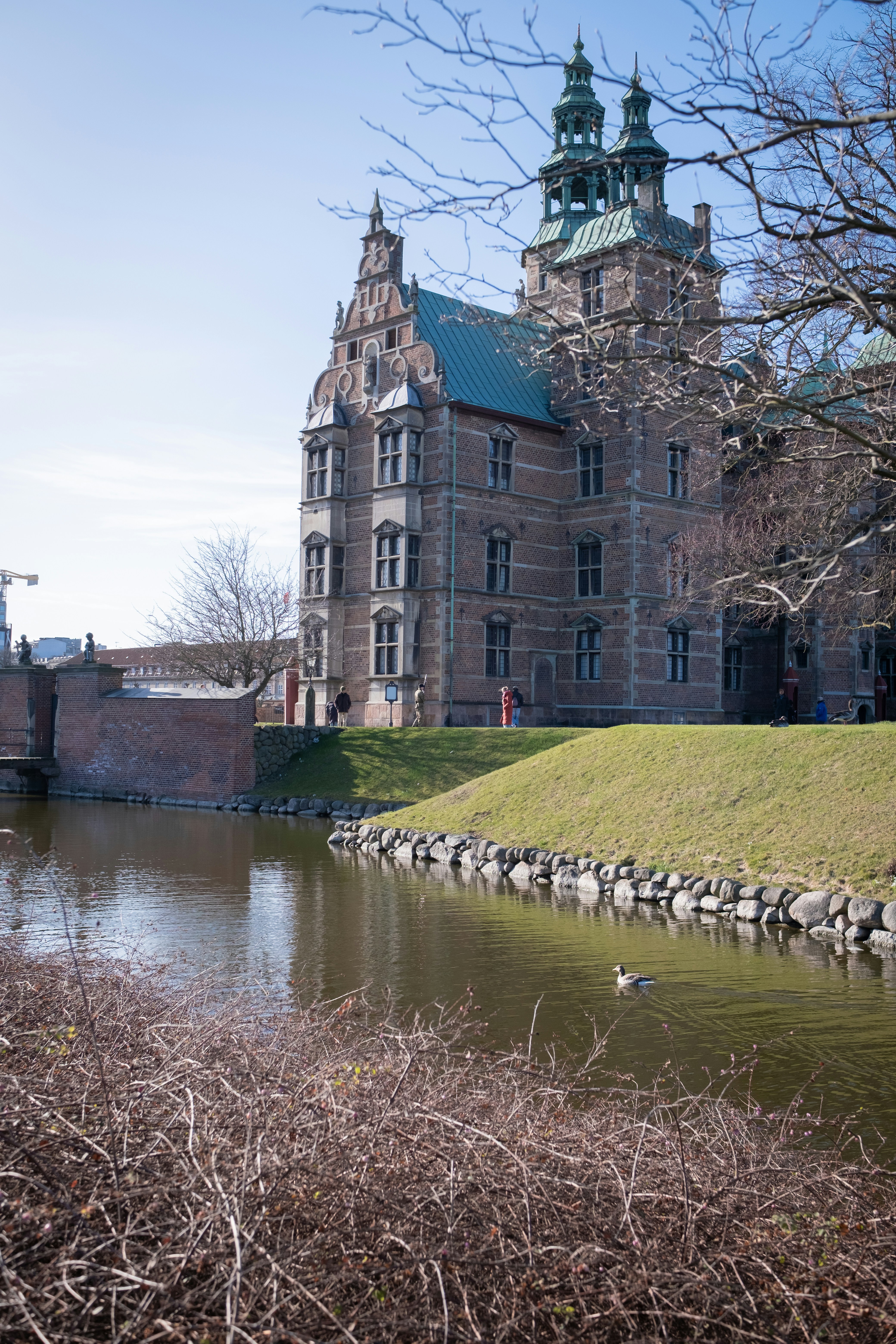 A beautiful castle sits beside water.