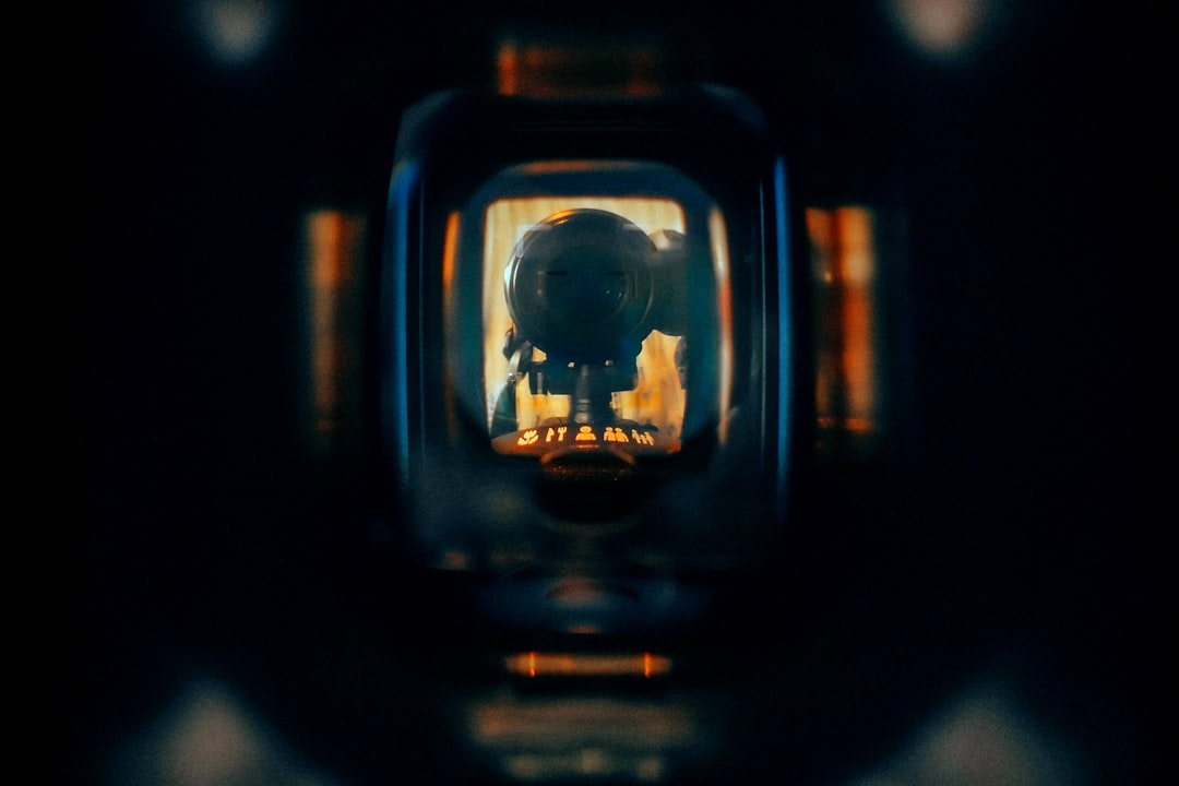A silhouette is viewed through a dark screen., Reflection of a camera in the viewfinder of a camera