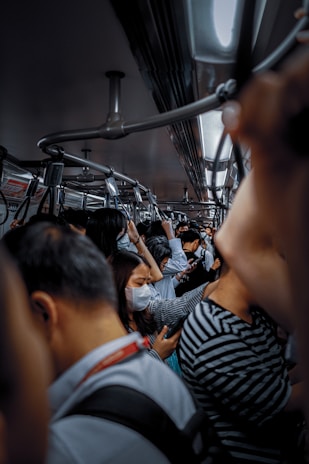 A crowded train during a pandemic.