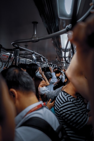 A crowded train during a pandemic.