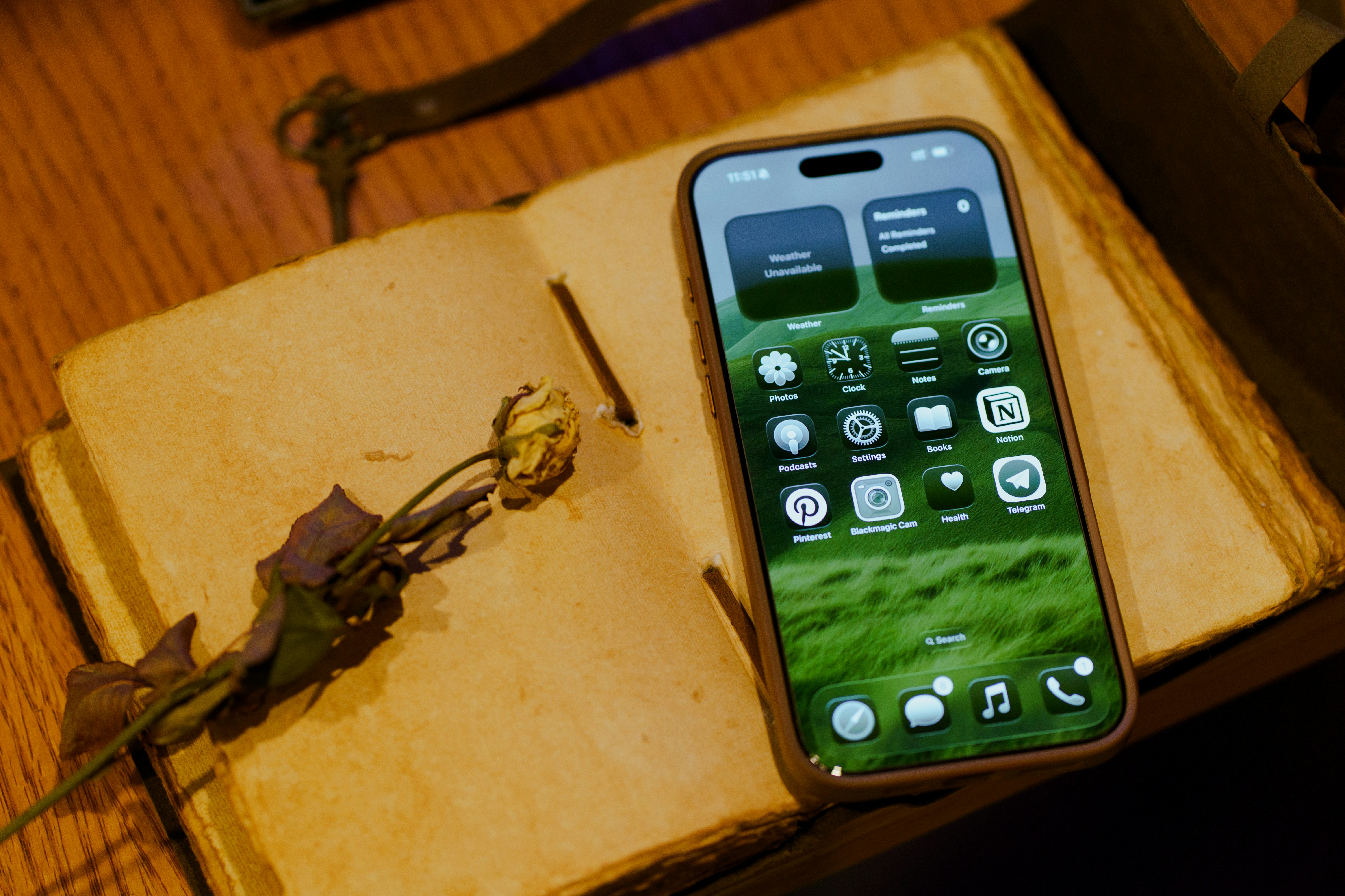 A smartphone rests on a vintage book.