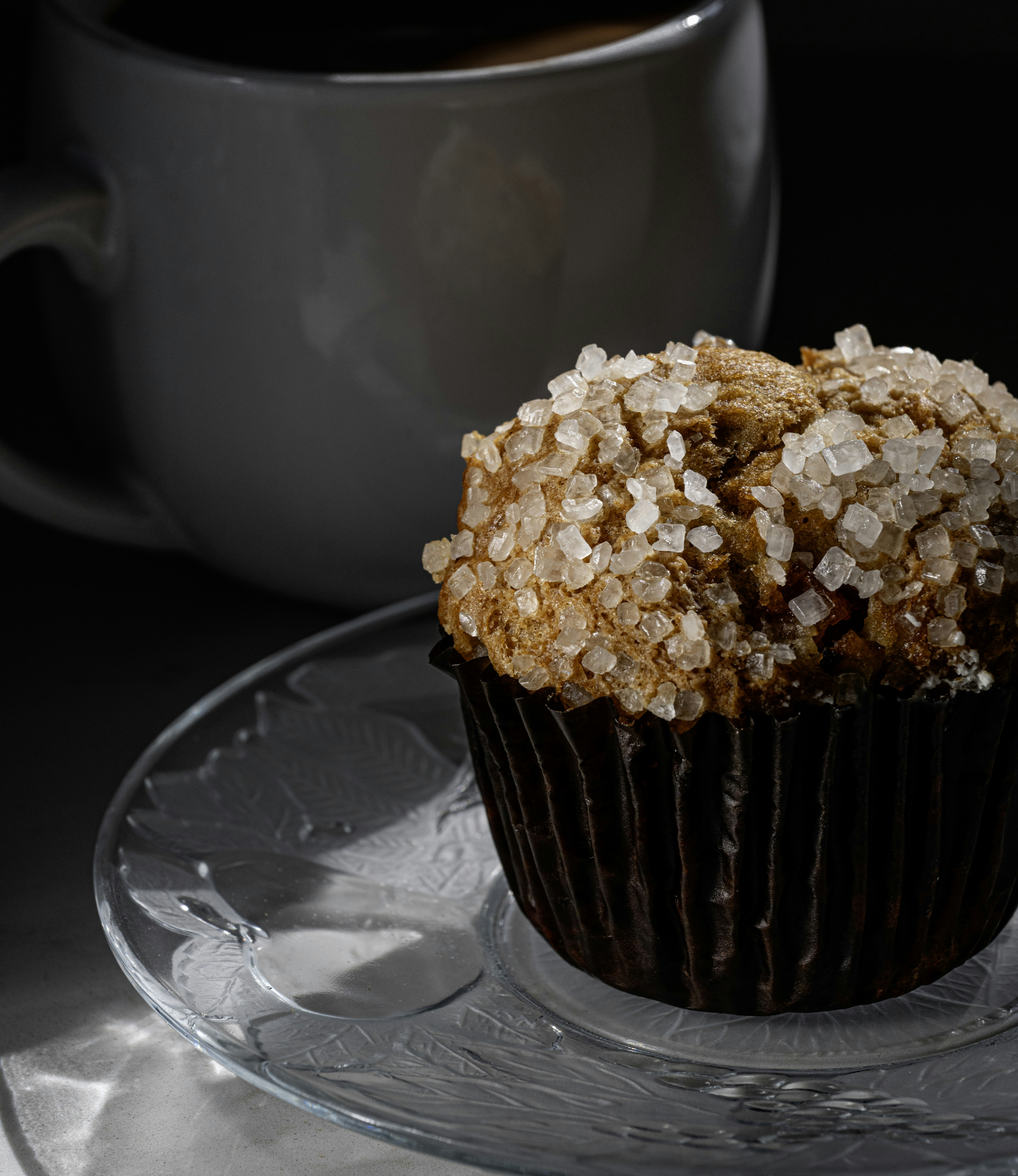Muffin with crystals and coffee ready to enjoy.