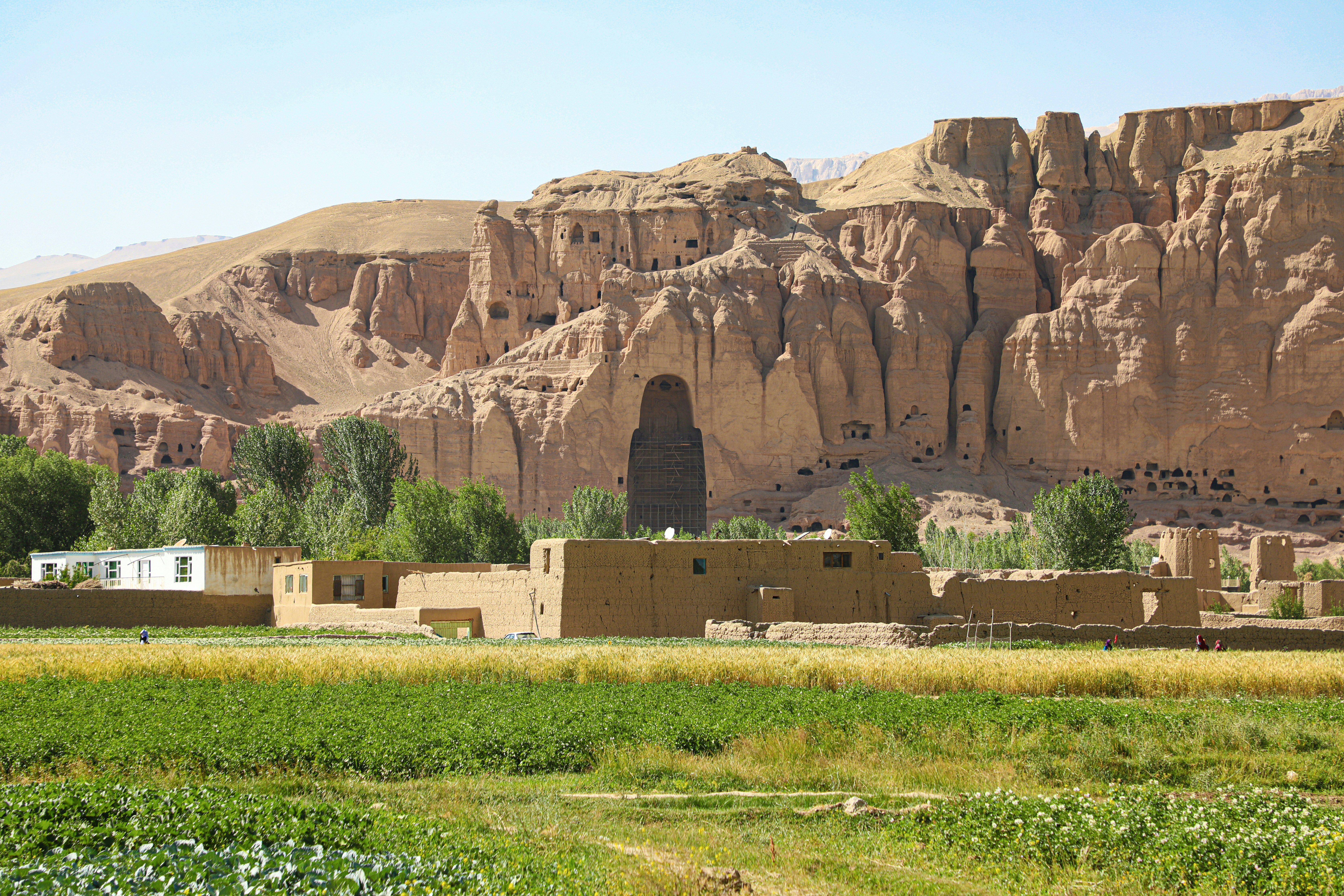 Ancient buddha statue ruins with surrounding landscape.