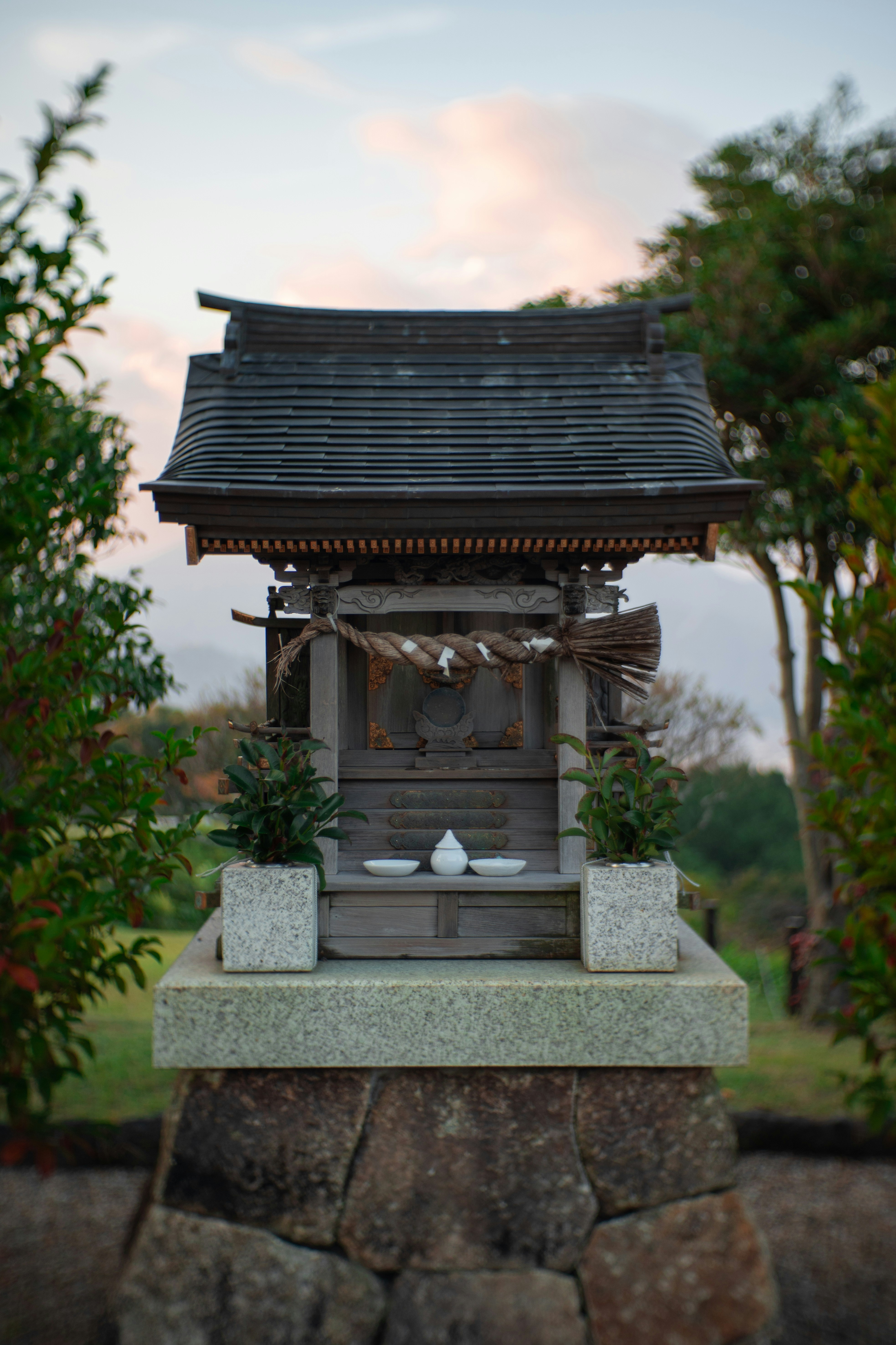 A small japanese shinto shrine in nature.
