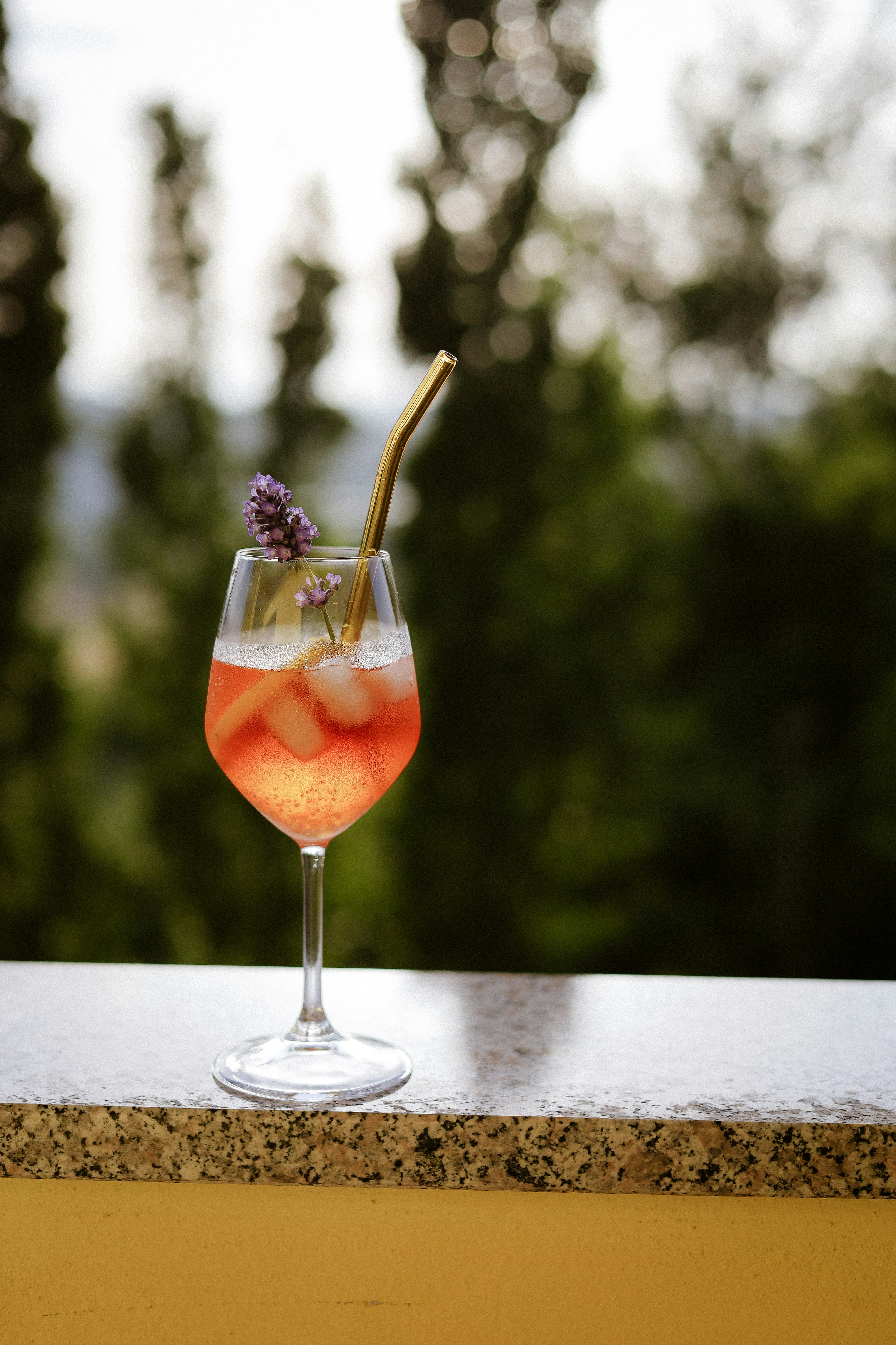 A refreshing cocktail is decorated with lavender.