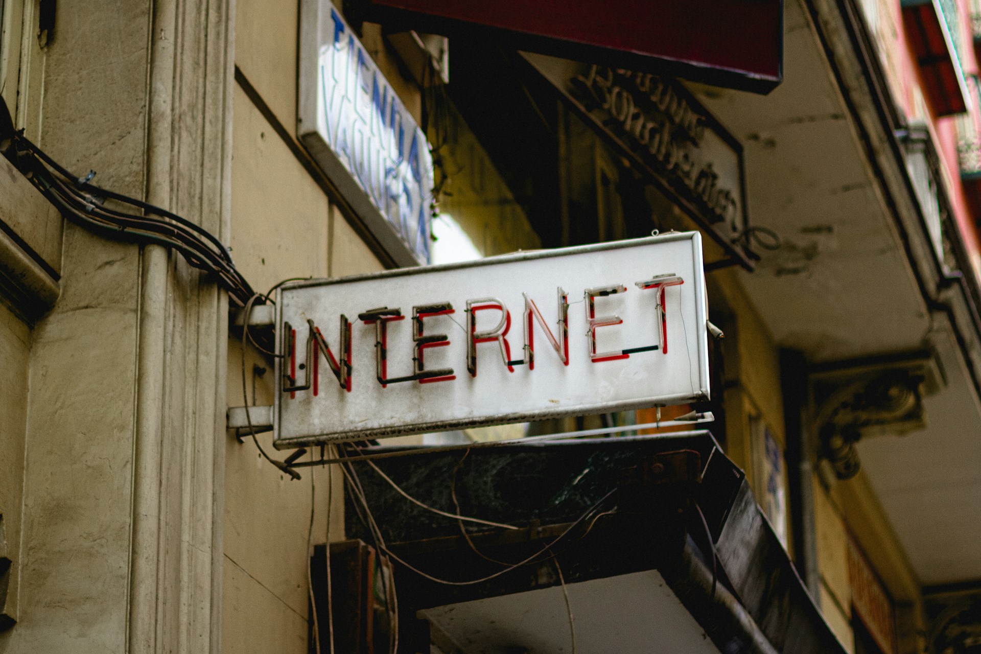 An "internet" sign hangs on a building's exterior.