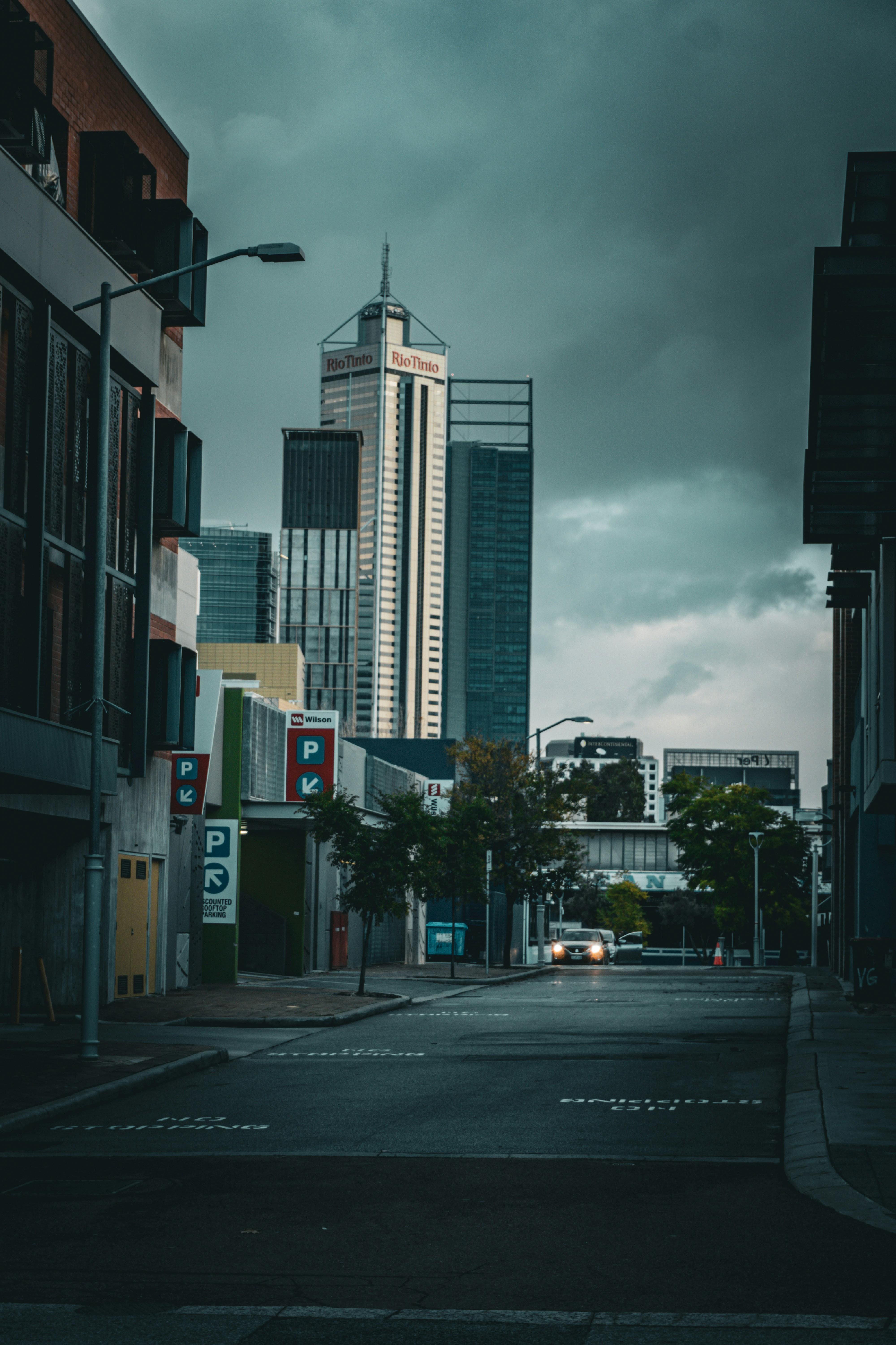 City street view with tall buildings in the distance.
