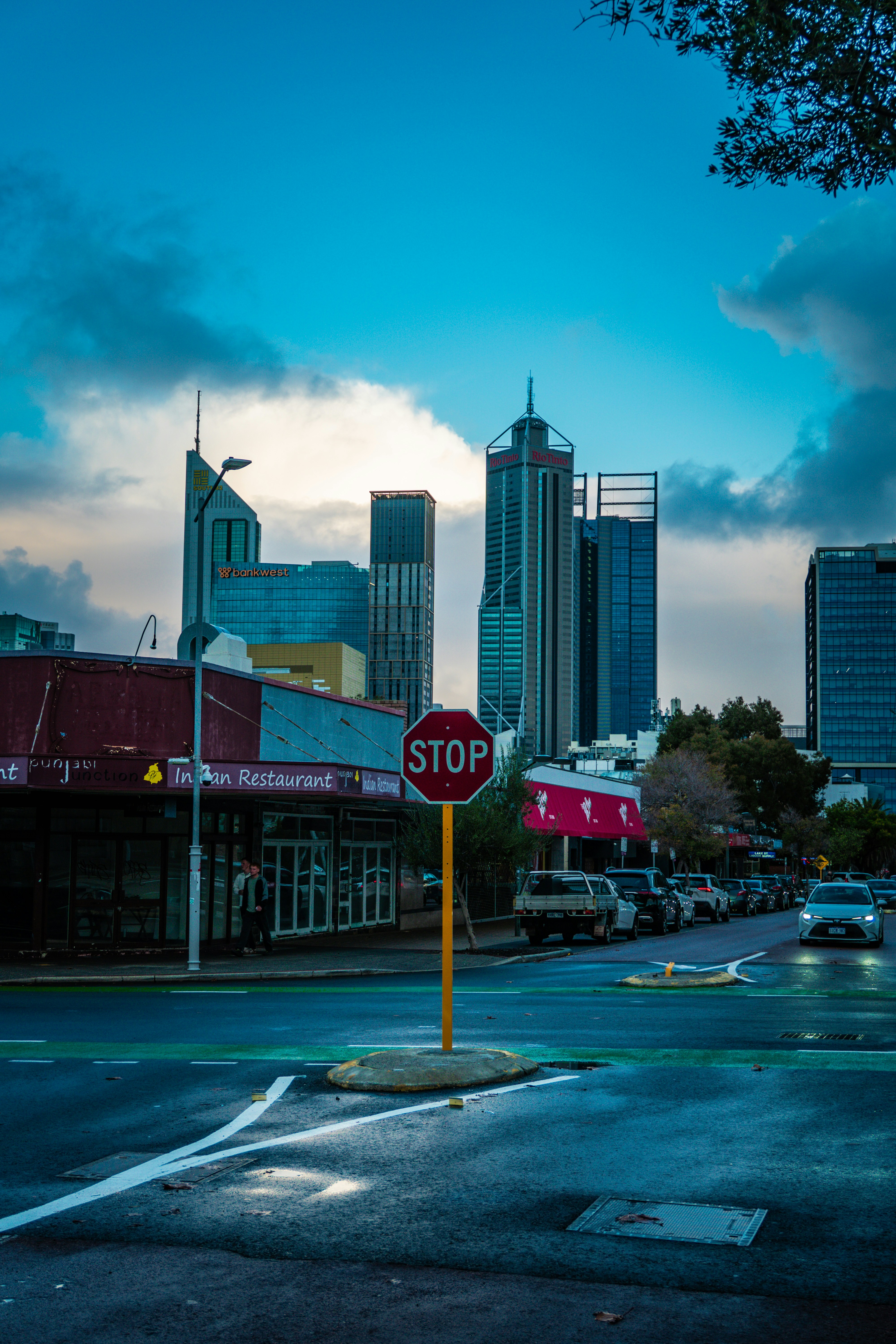 Stop sign in front of city buildings.