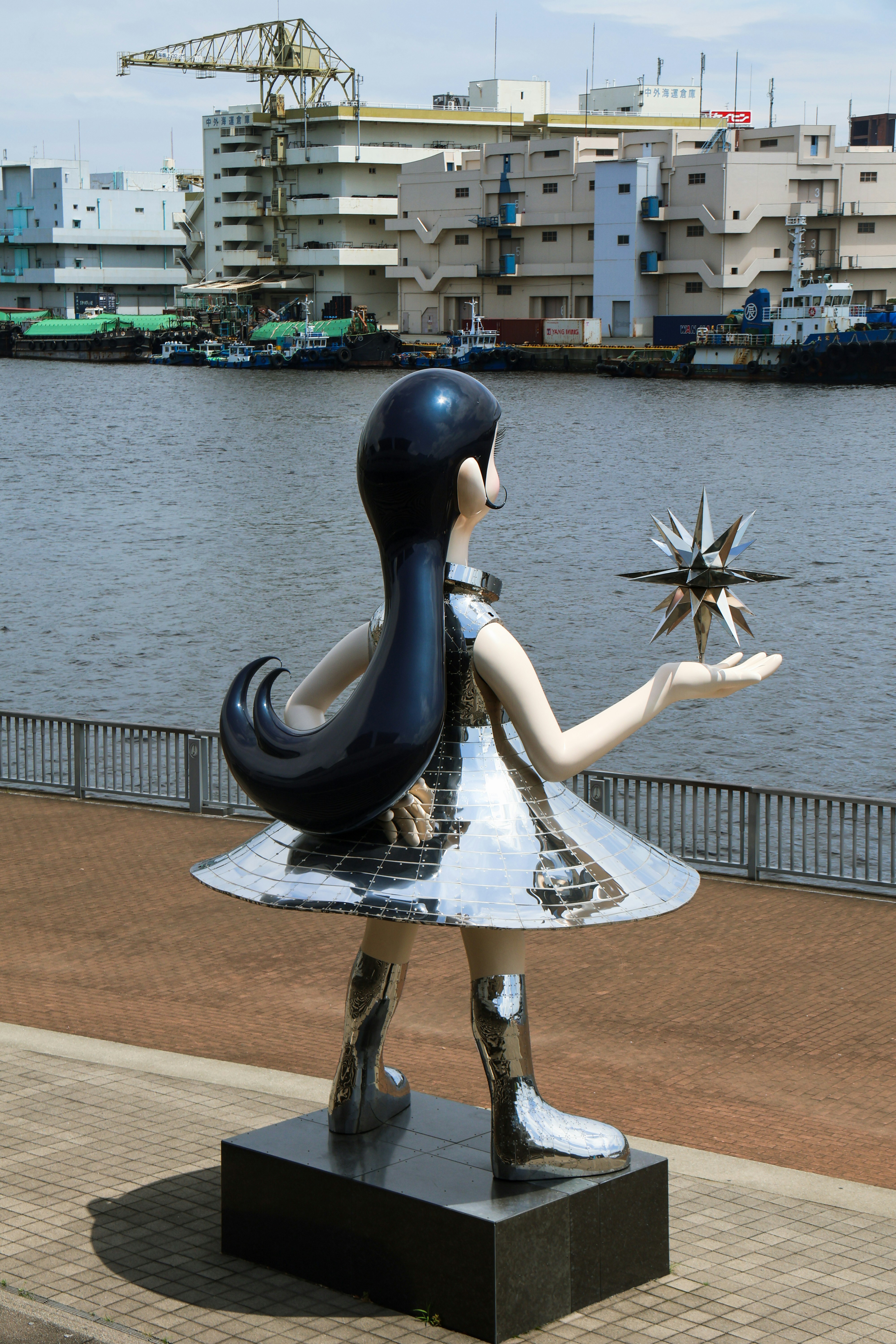 A shiny statue of a girl holding a star.