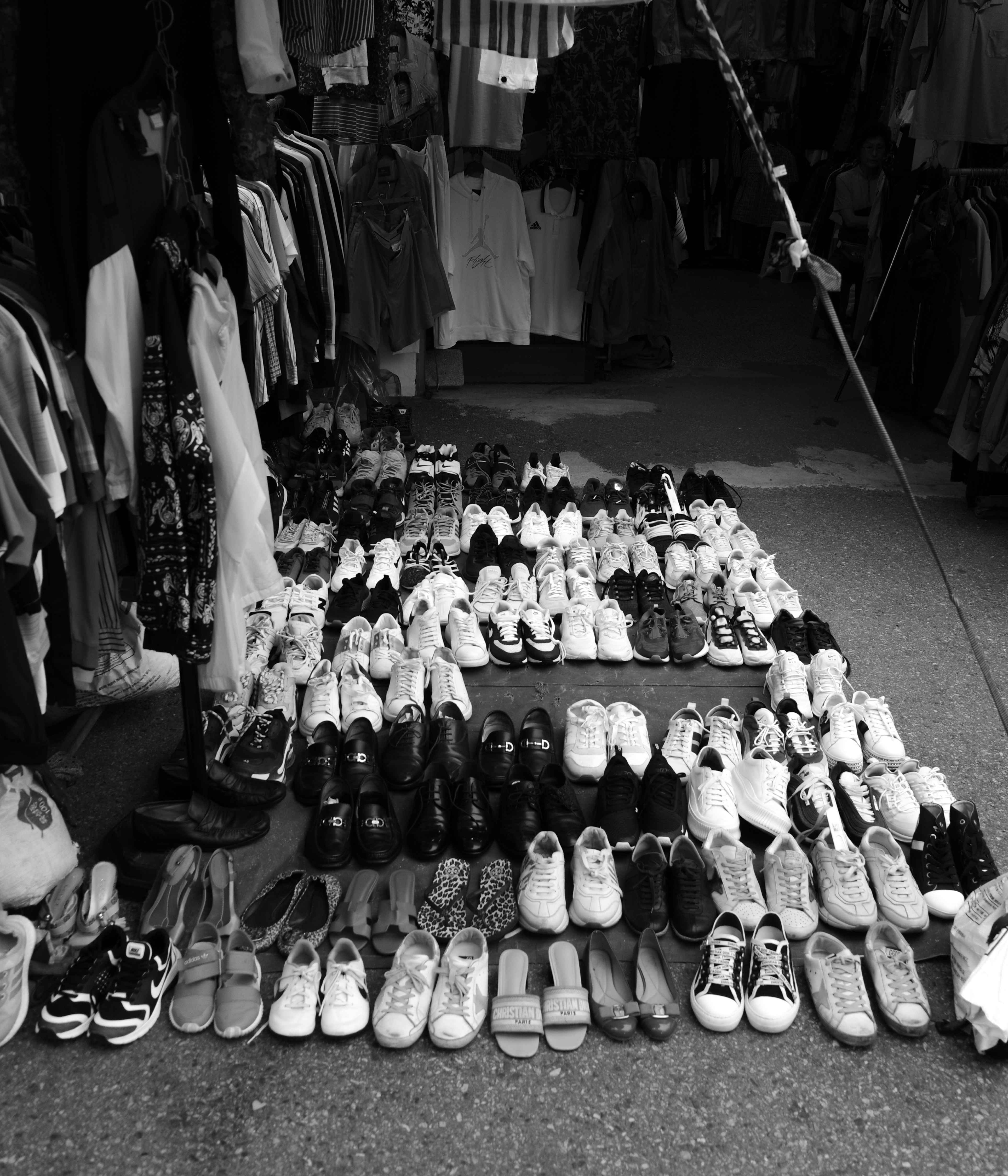 Shoes are displayed for sale at a market.
