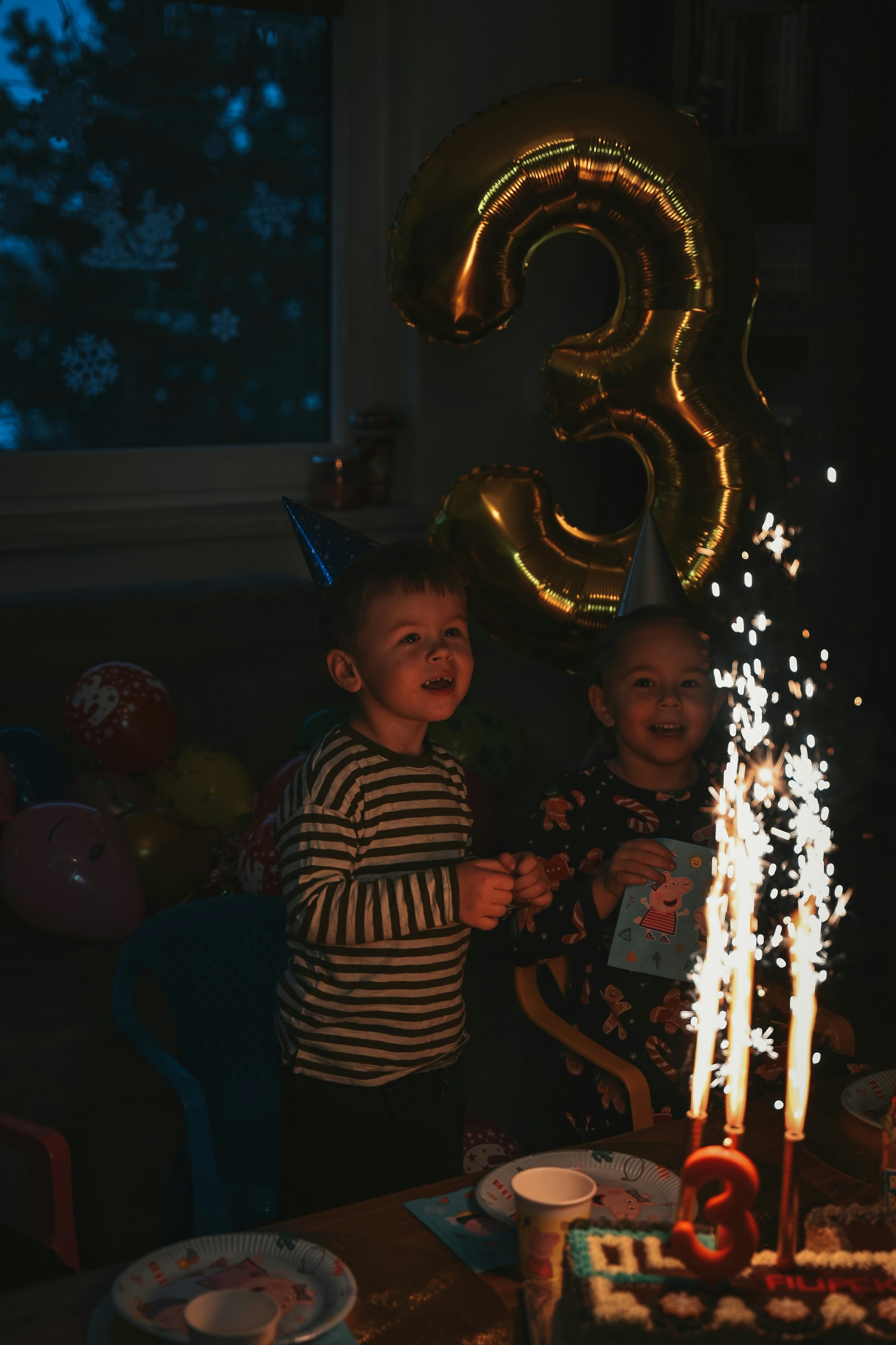 Happy kids celebrate a third birthday with sparkles.