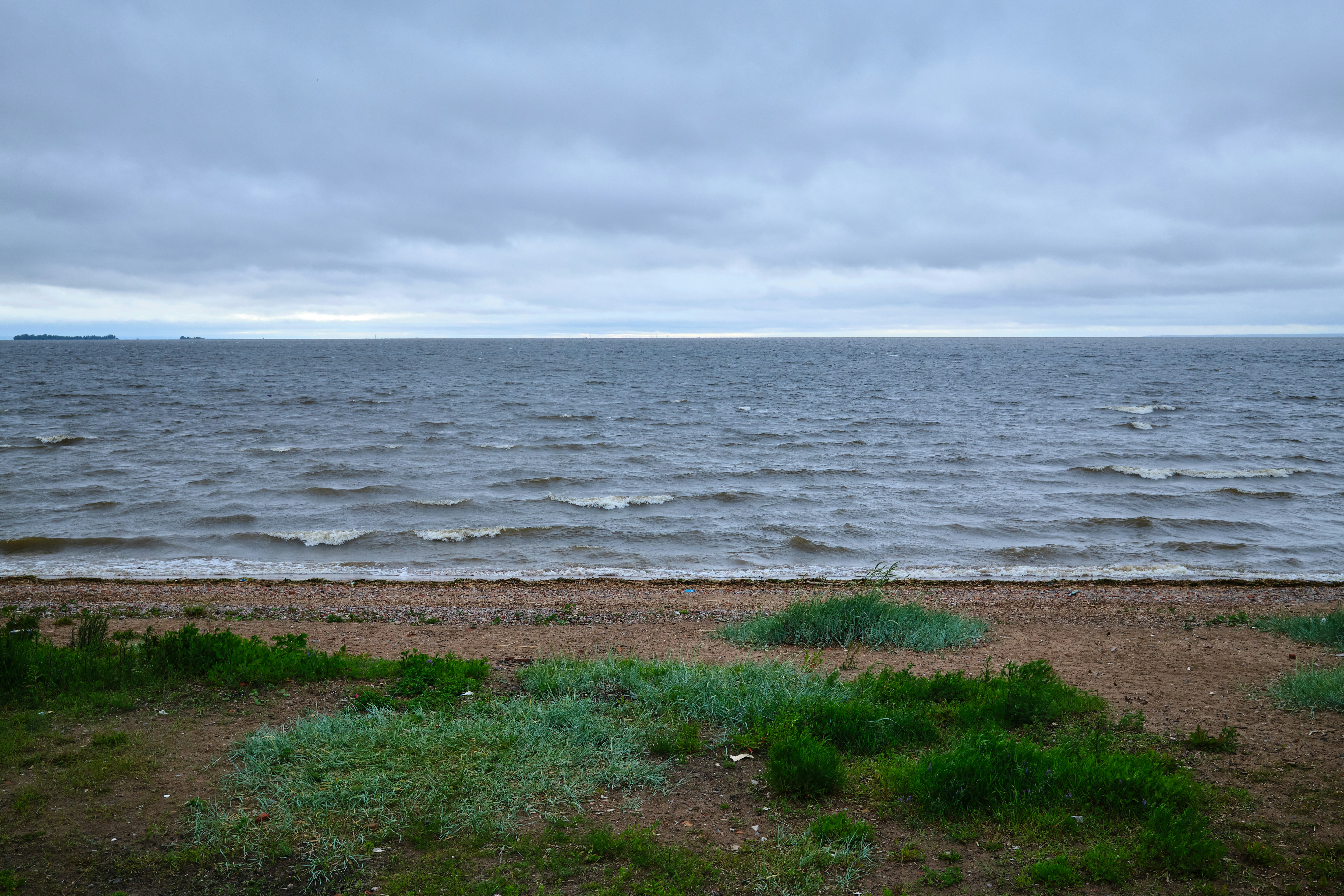 A cloudy sky over the sea and shore.