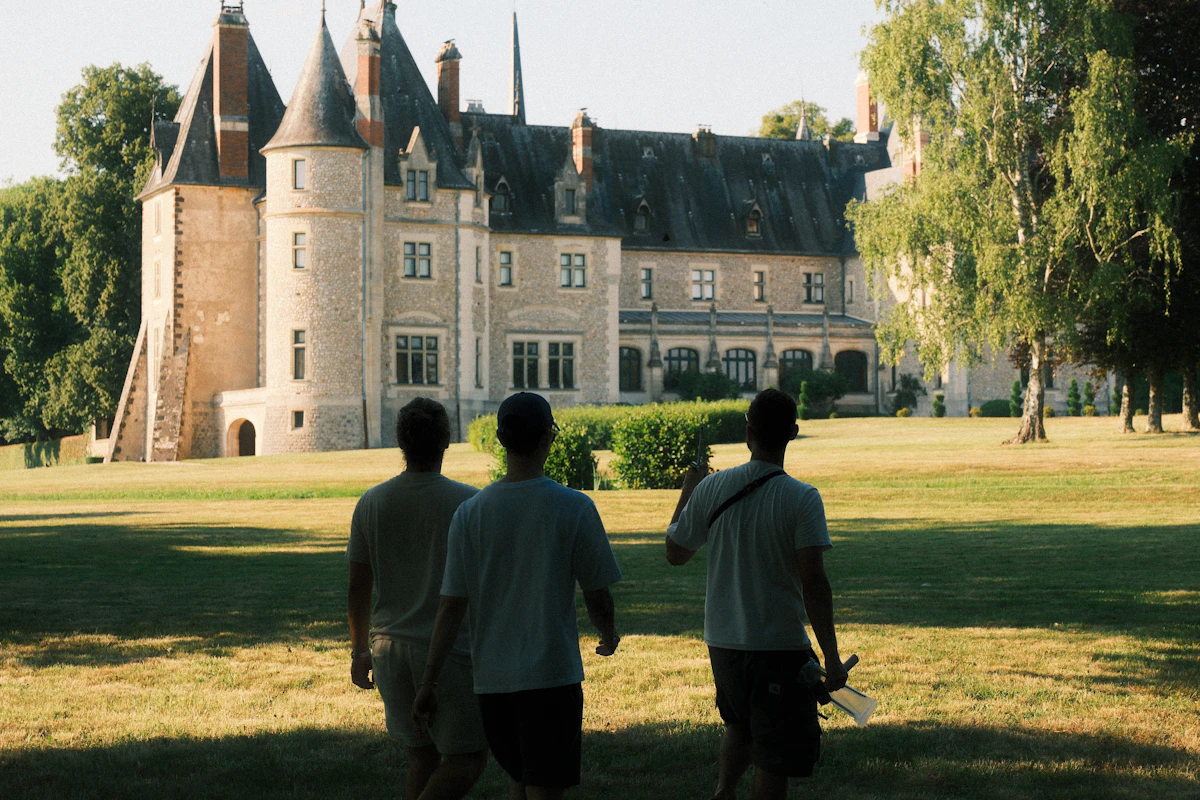 Historic European castle set in landscaped grounds, viewed from the lawn