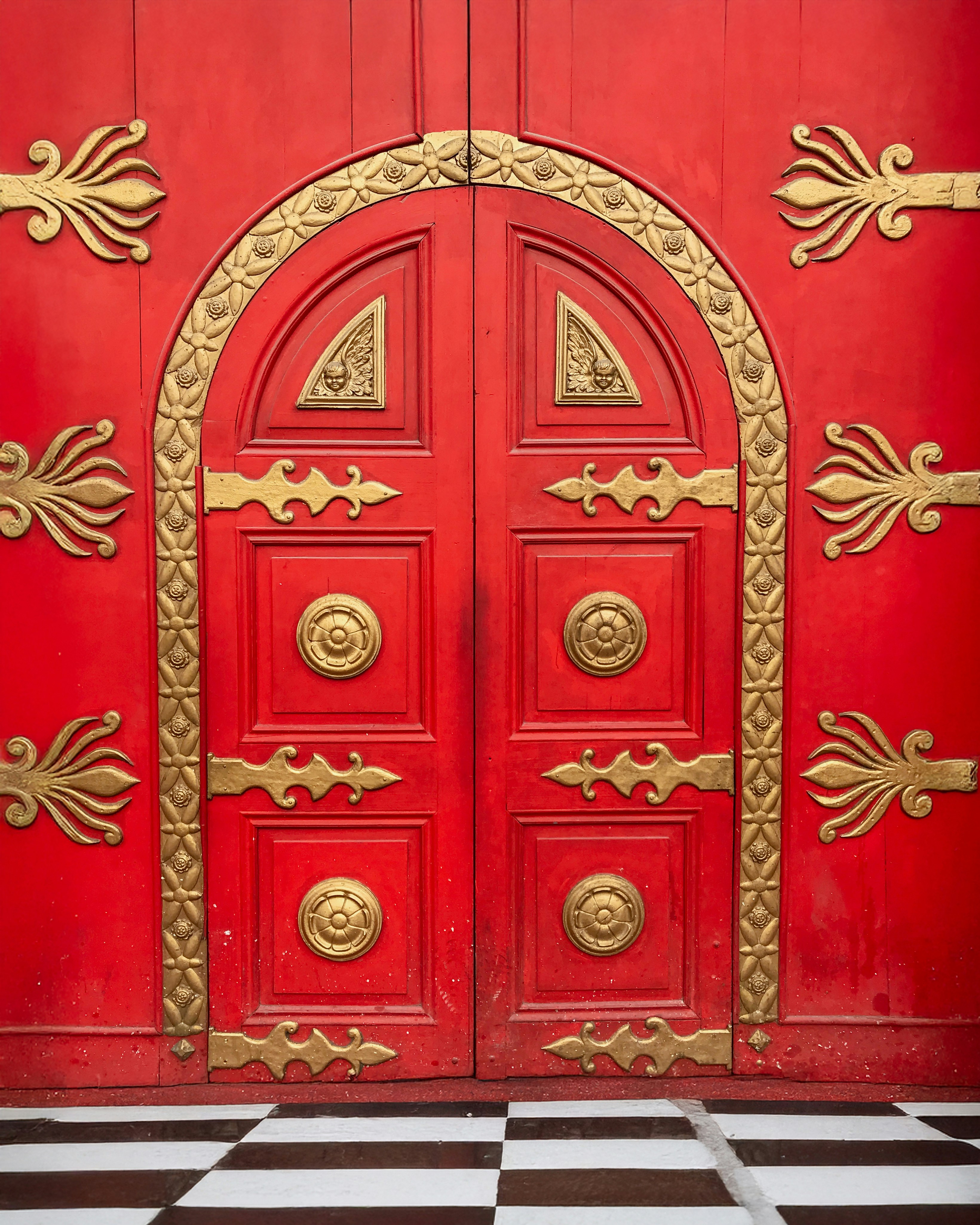 Red ornate doors with gold accents.