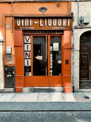 A charming orange storefront sells wines and liquors.