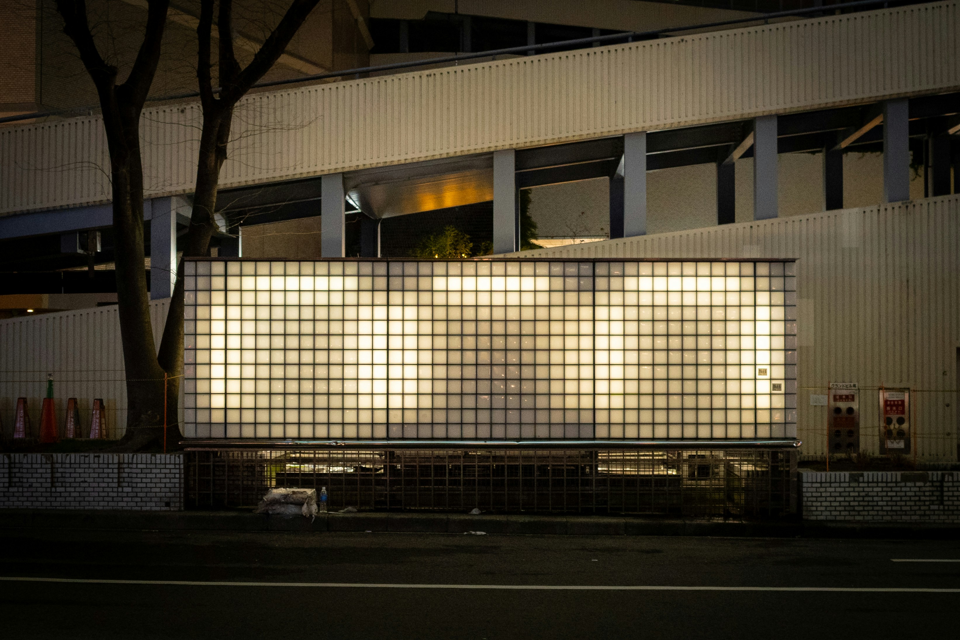 Japanese police box (koban) exterior at night, with lights on