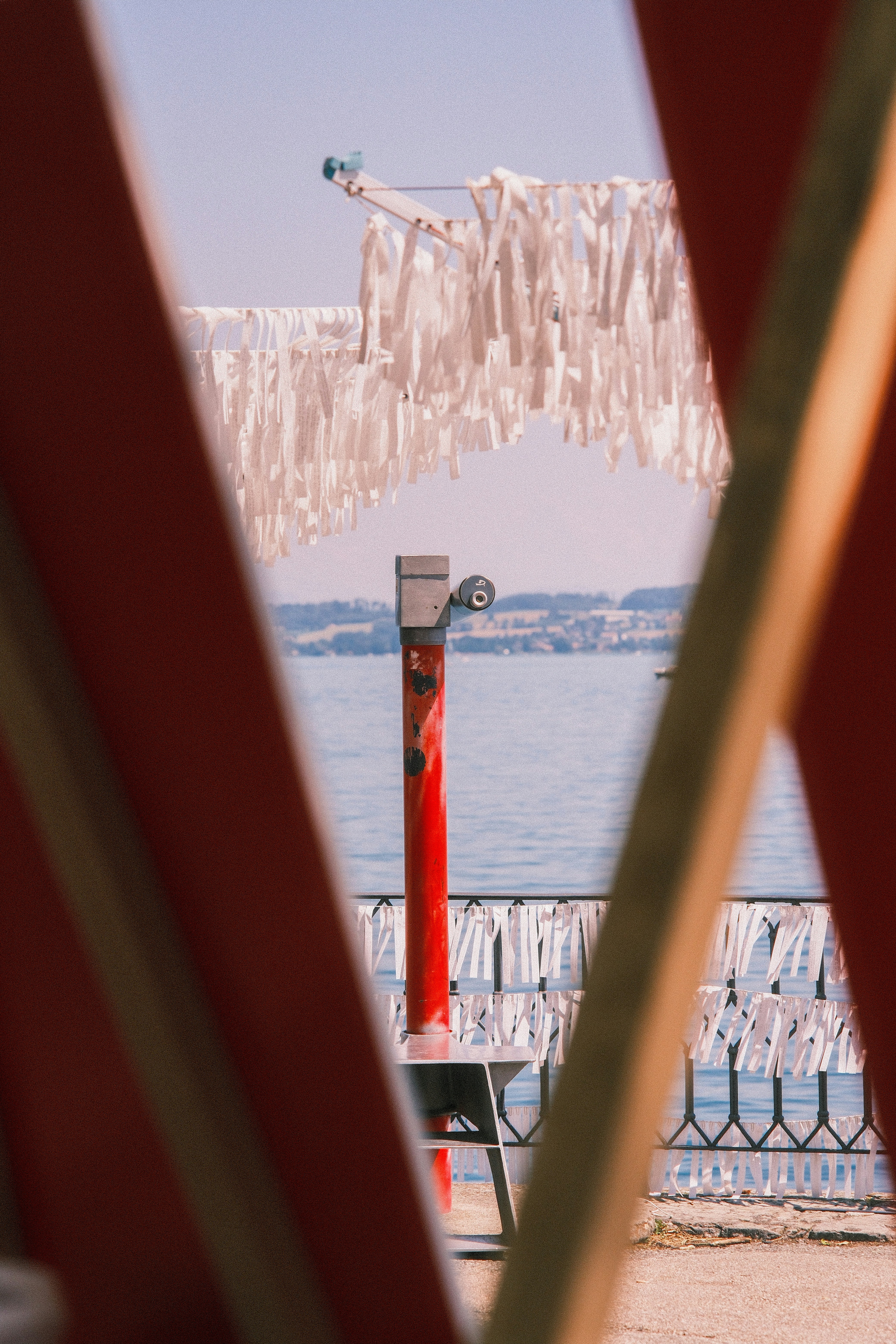 Wish ribbons hang near a body of water.