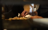 A chef adds finishing touches to a dish.