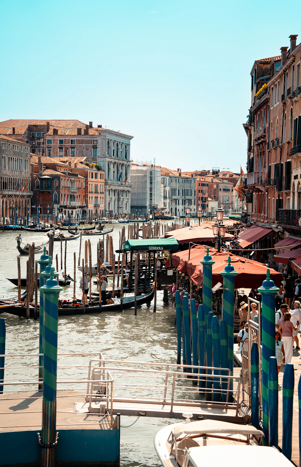 A Venetian canal, old buildings and gondolas glowing in evening light