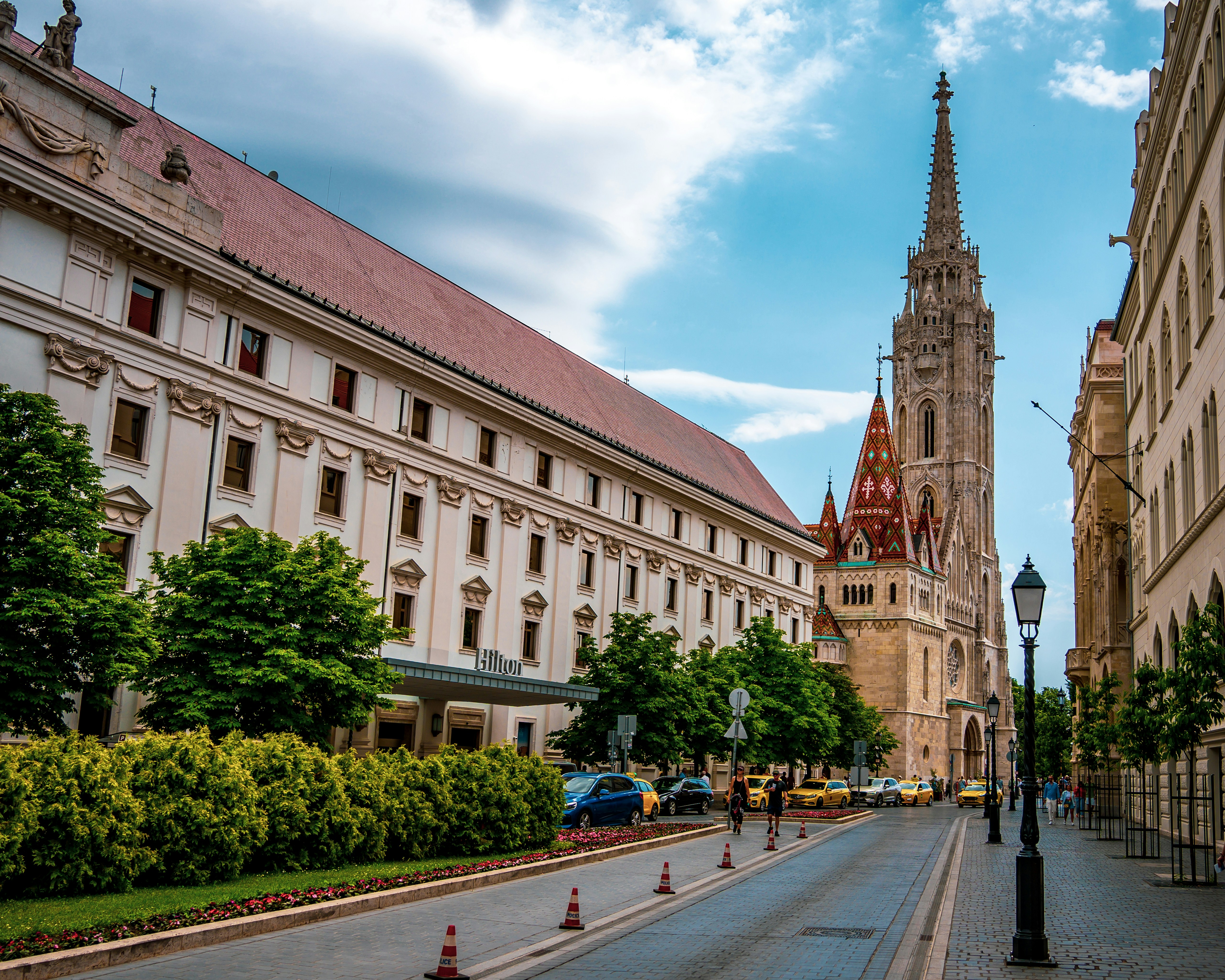 A beautiful street with historic buildings and a church.