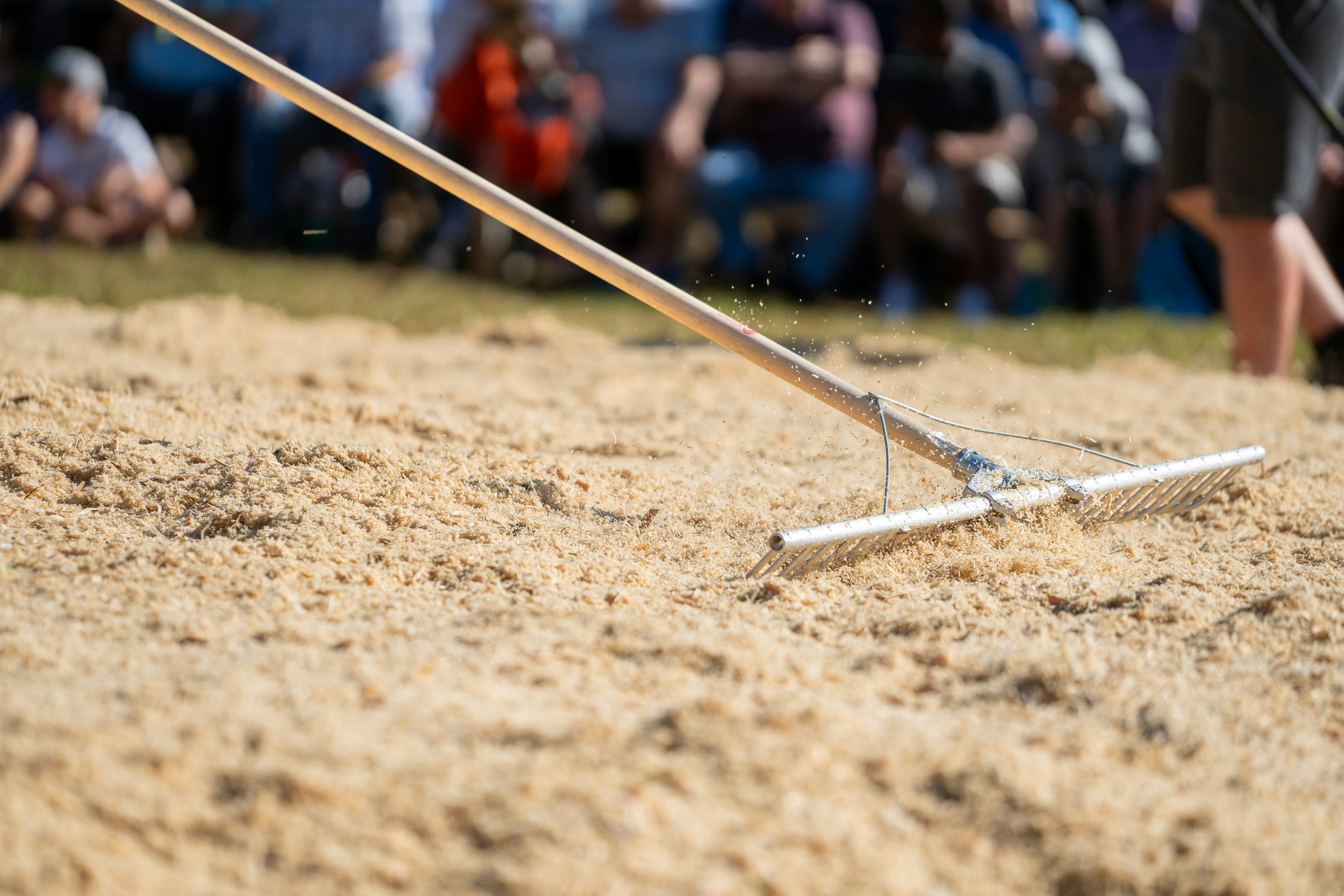 A rake is used to smooth the sand.