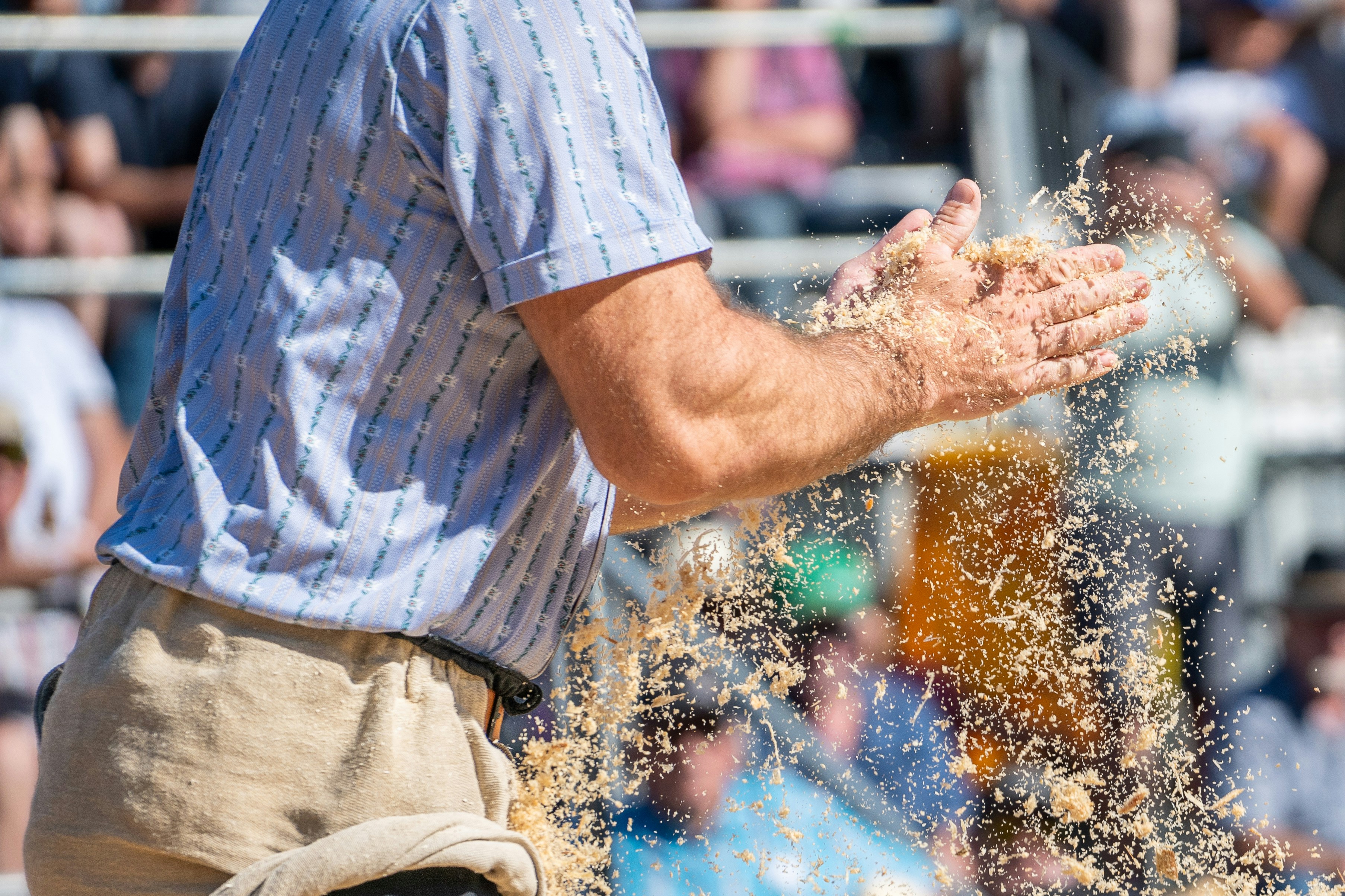 Man throws sawdust into the air.