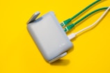 Router with cables plugged in, on yellow background.