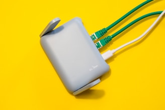 Router with cables plugged in, on yellow background.