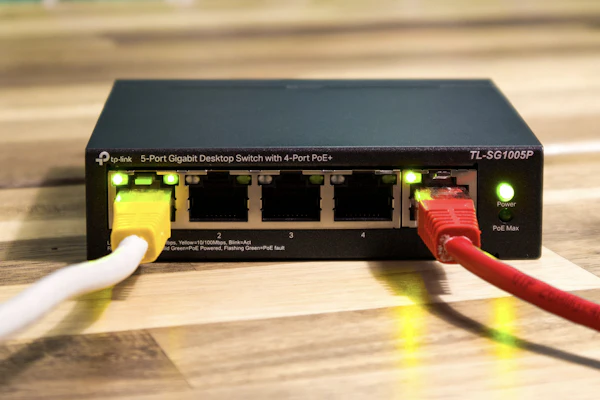 A network switch with ethernet cables connected, representing stored configuration data