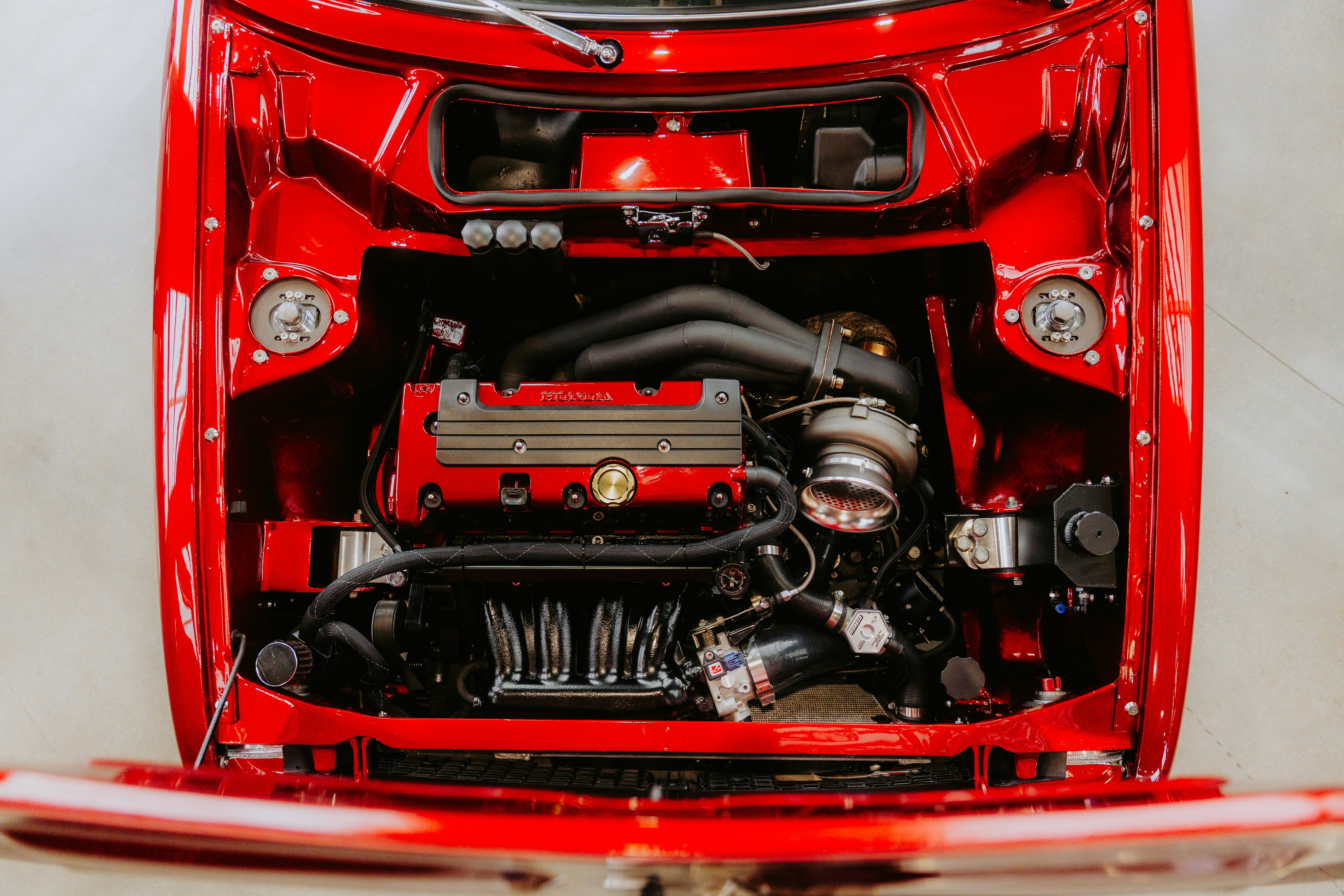 A red car's engine is on display.