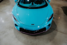 A bright blue sports car is pictured.
