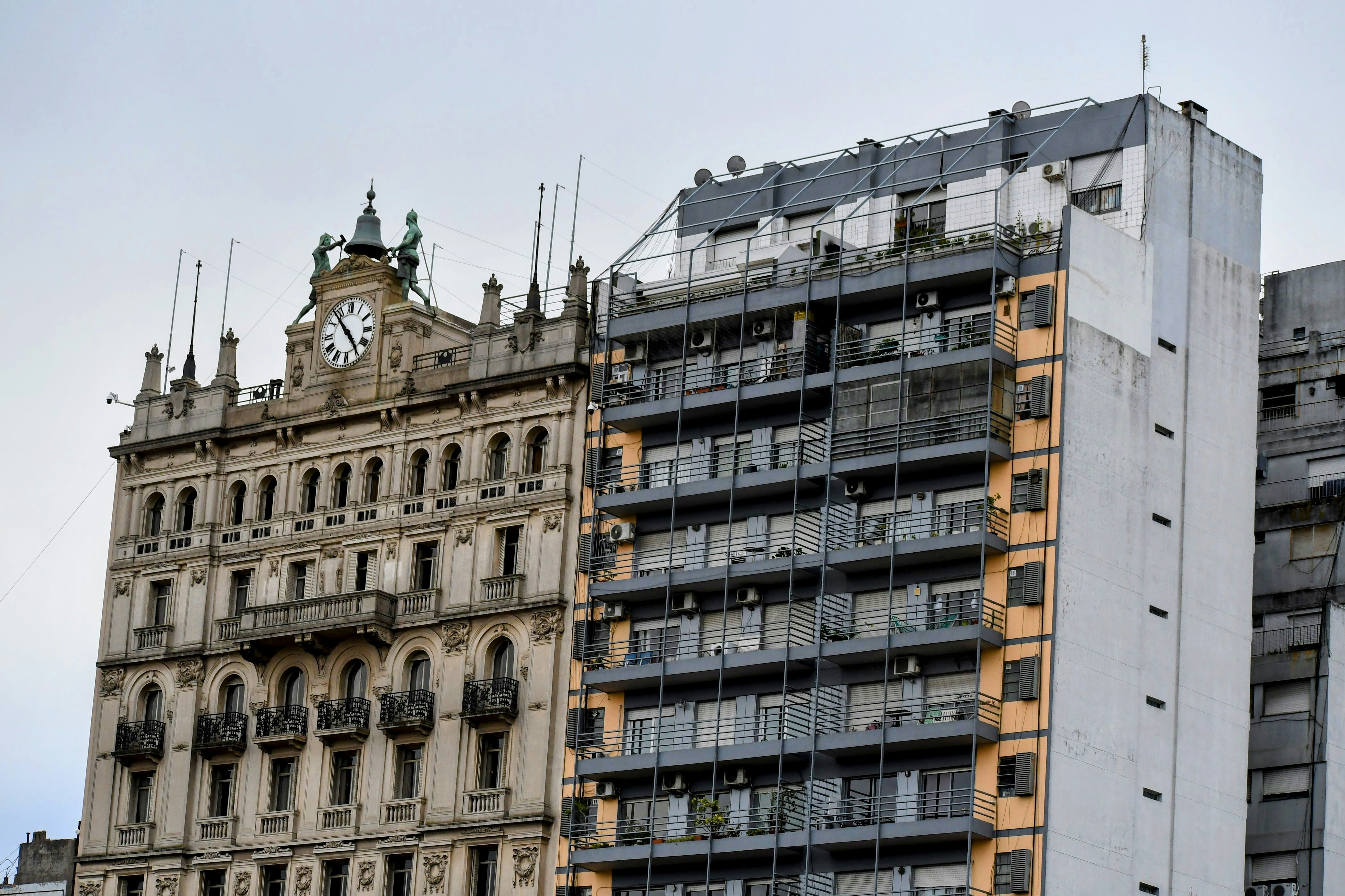 Two buildings with distinct architecture stand side-by-side.