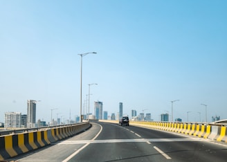 A road leads to buildings in the distance.