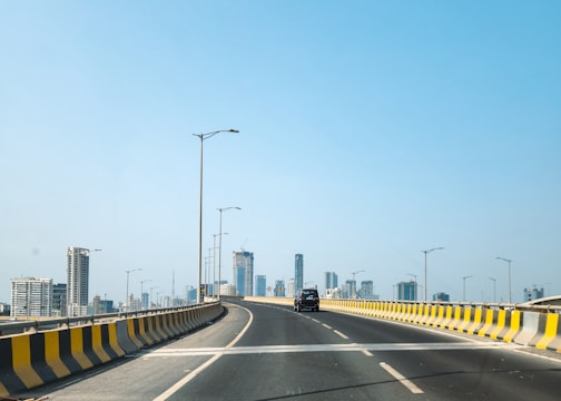 A road leads to buildings in the distance.