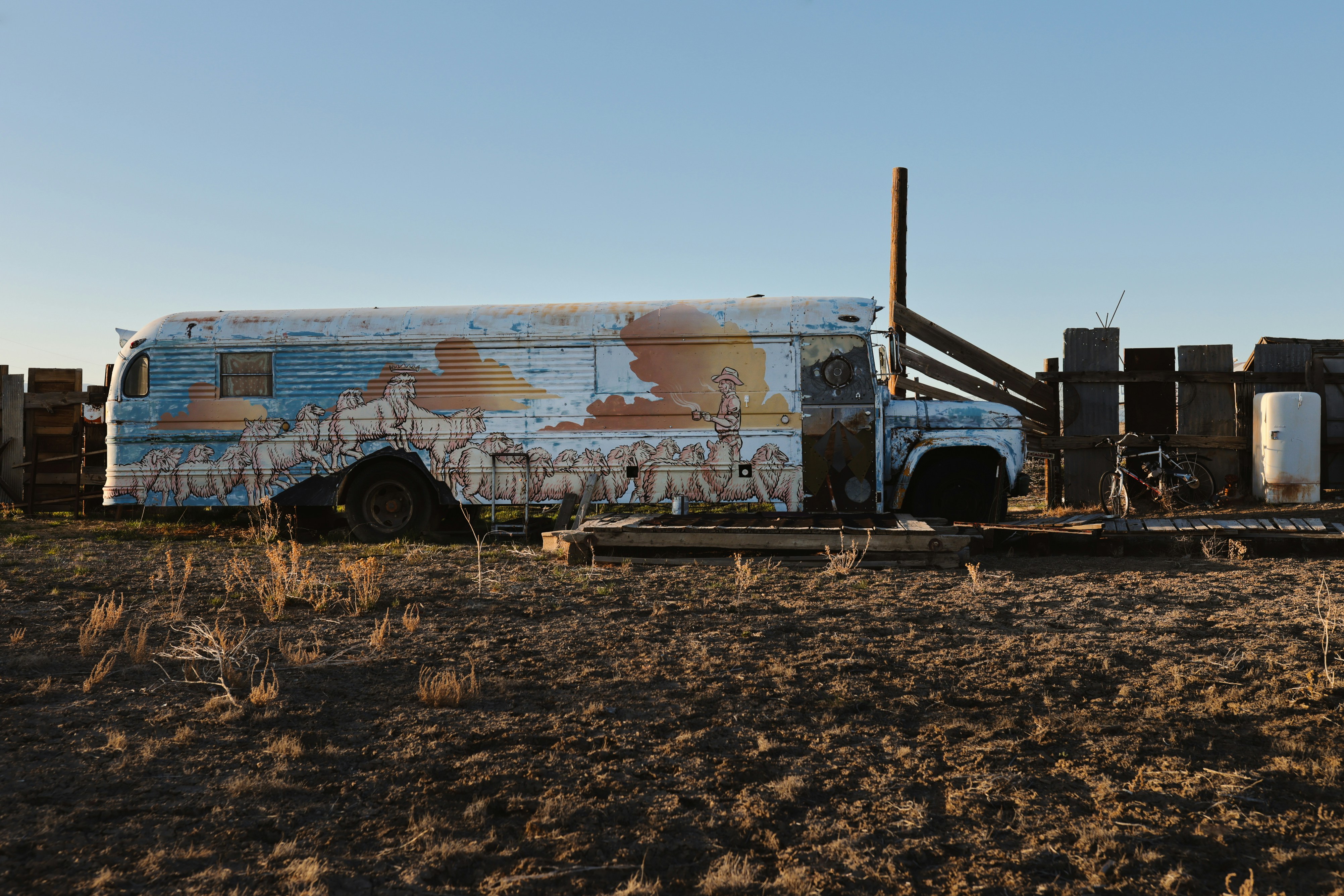 An old truck sits decaying outdoors.