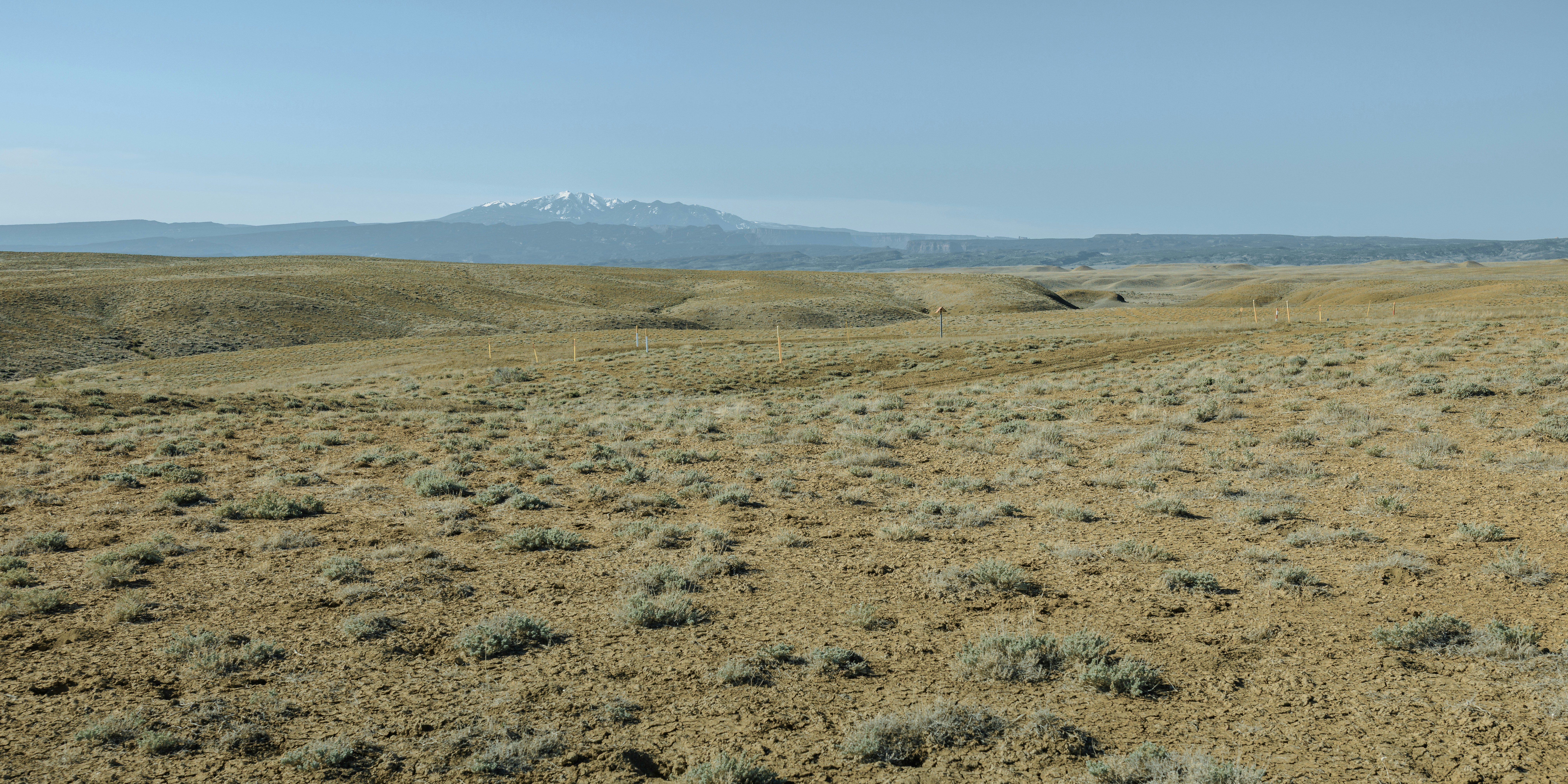 A barren landscape stretches towards distant mountains.