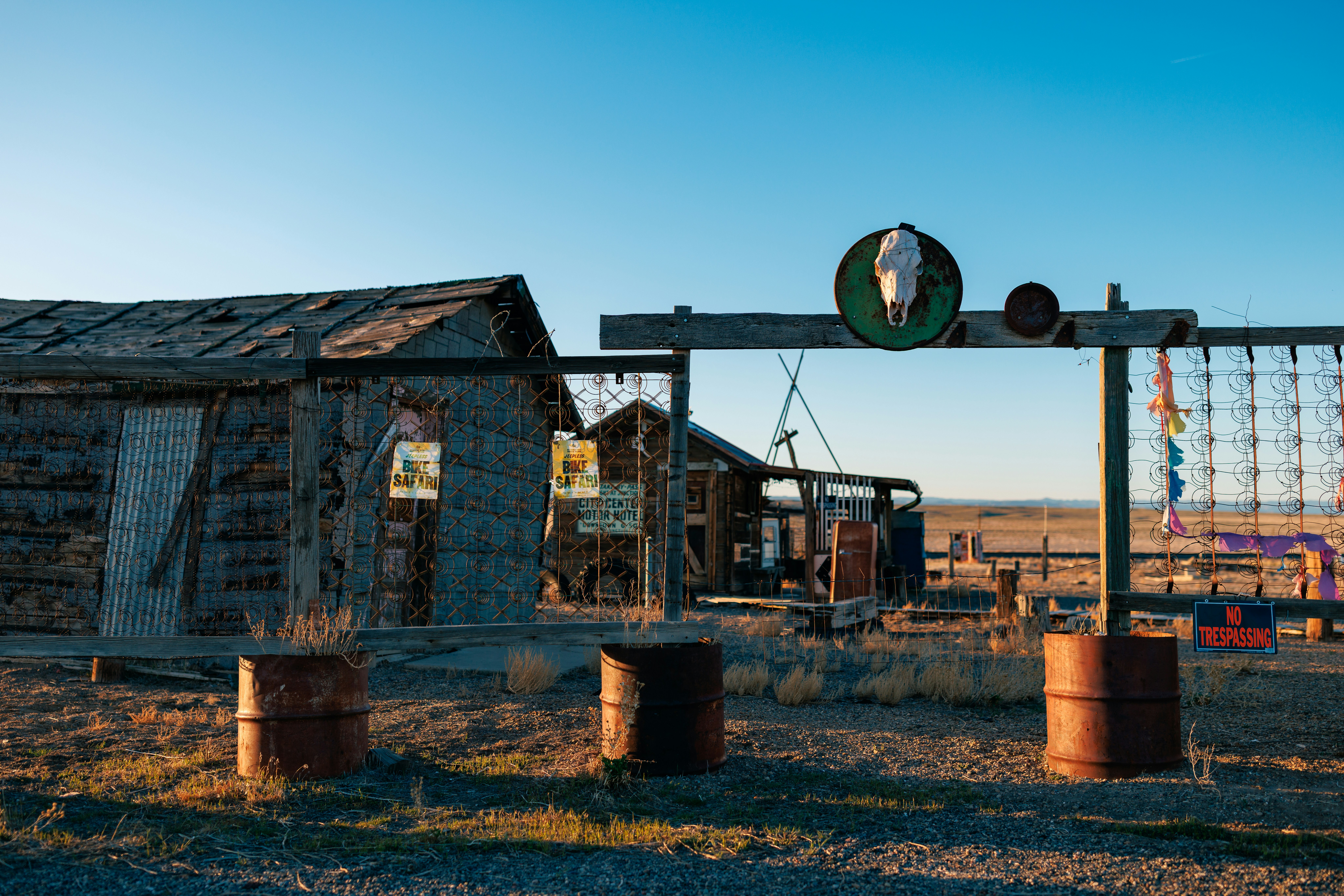 Old, rustic buildings stand under a bright, blue sky.