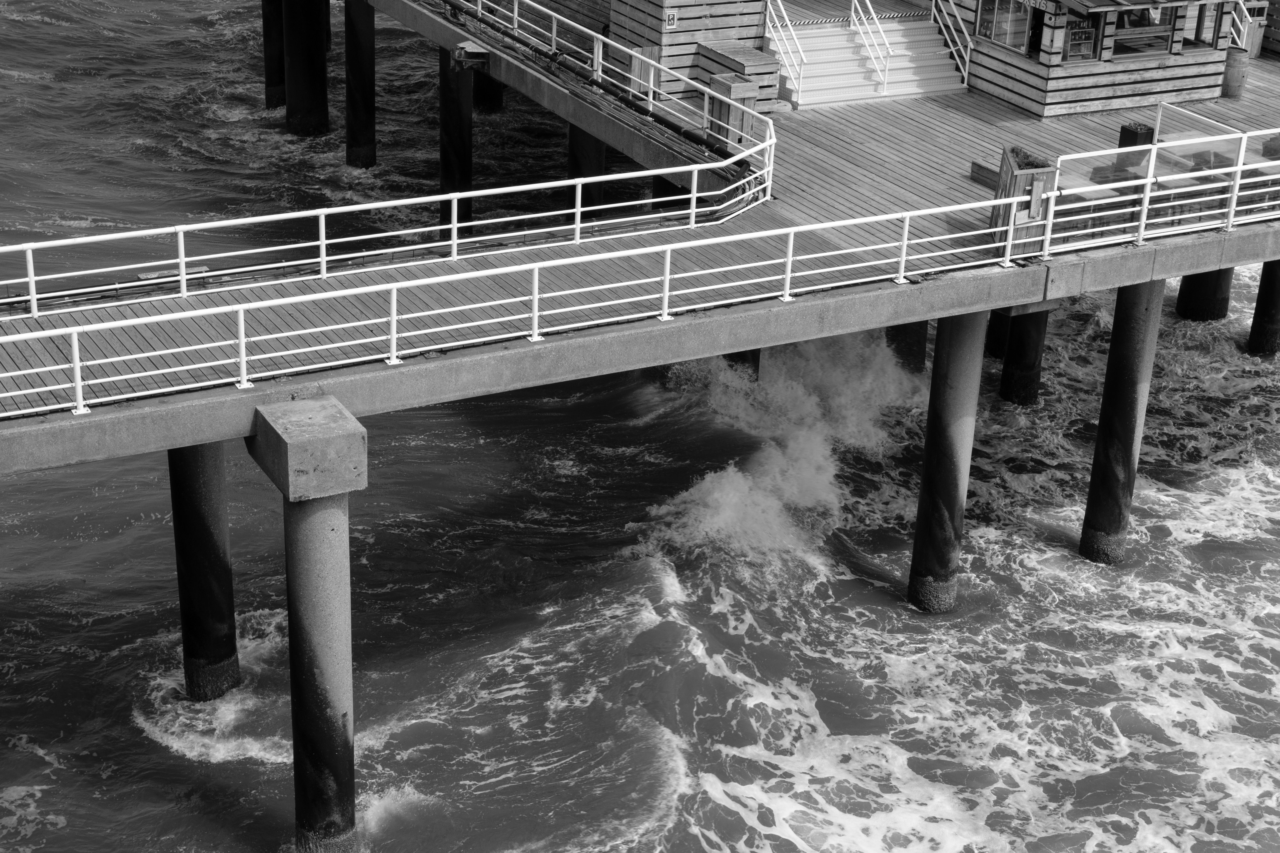 Waves under wooden pier