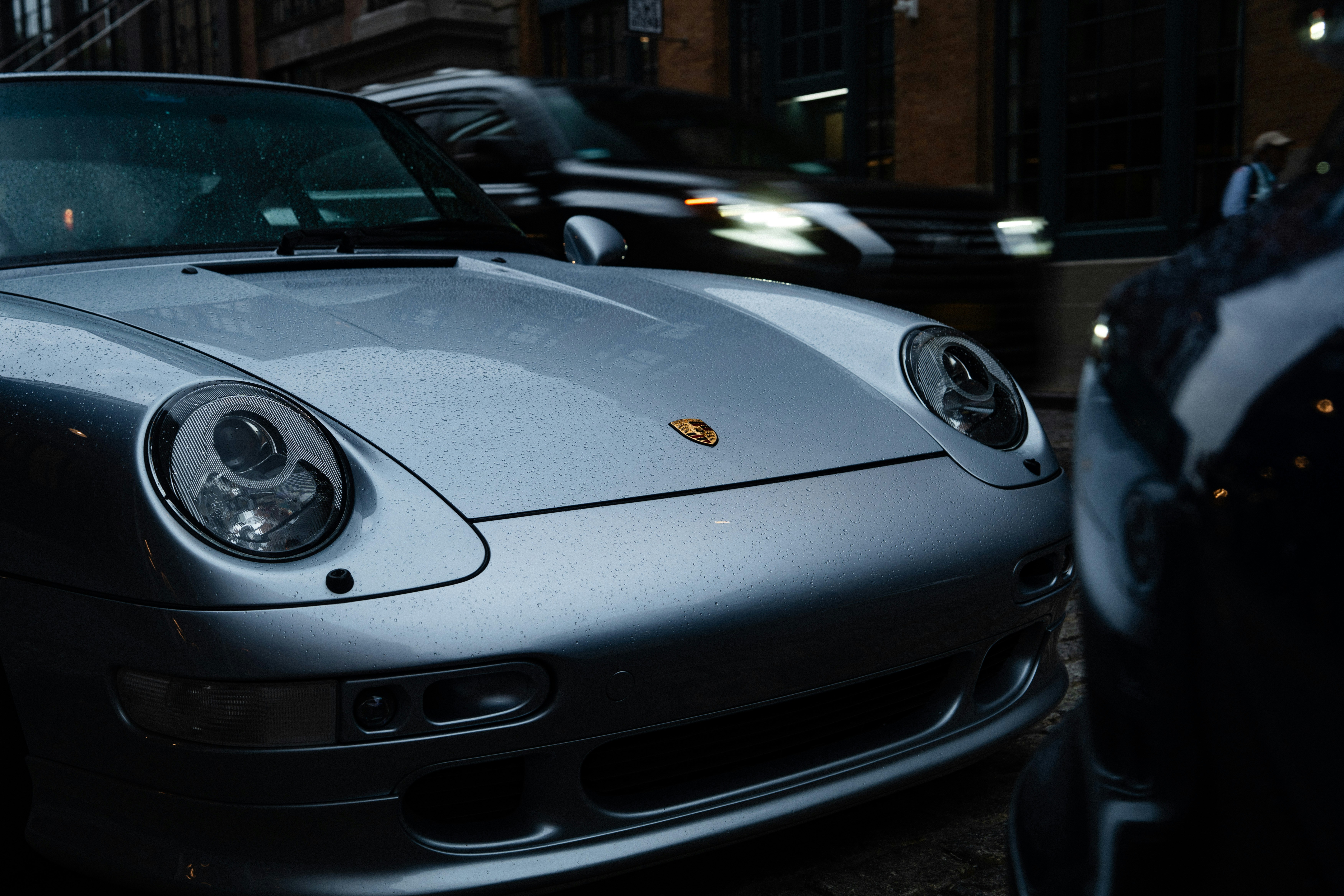 A silver Porsche 911 with a glossy finish.