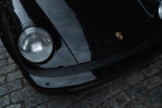 A black porsche 911's bumper is shown.