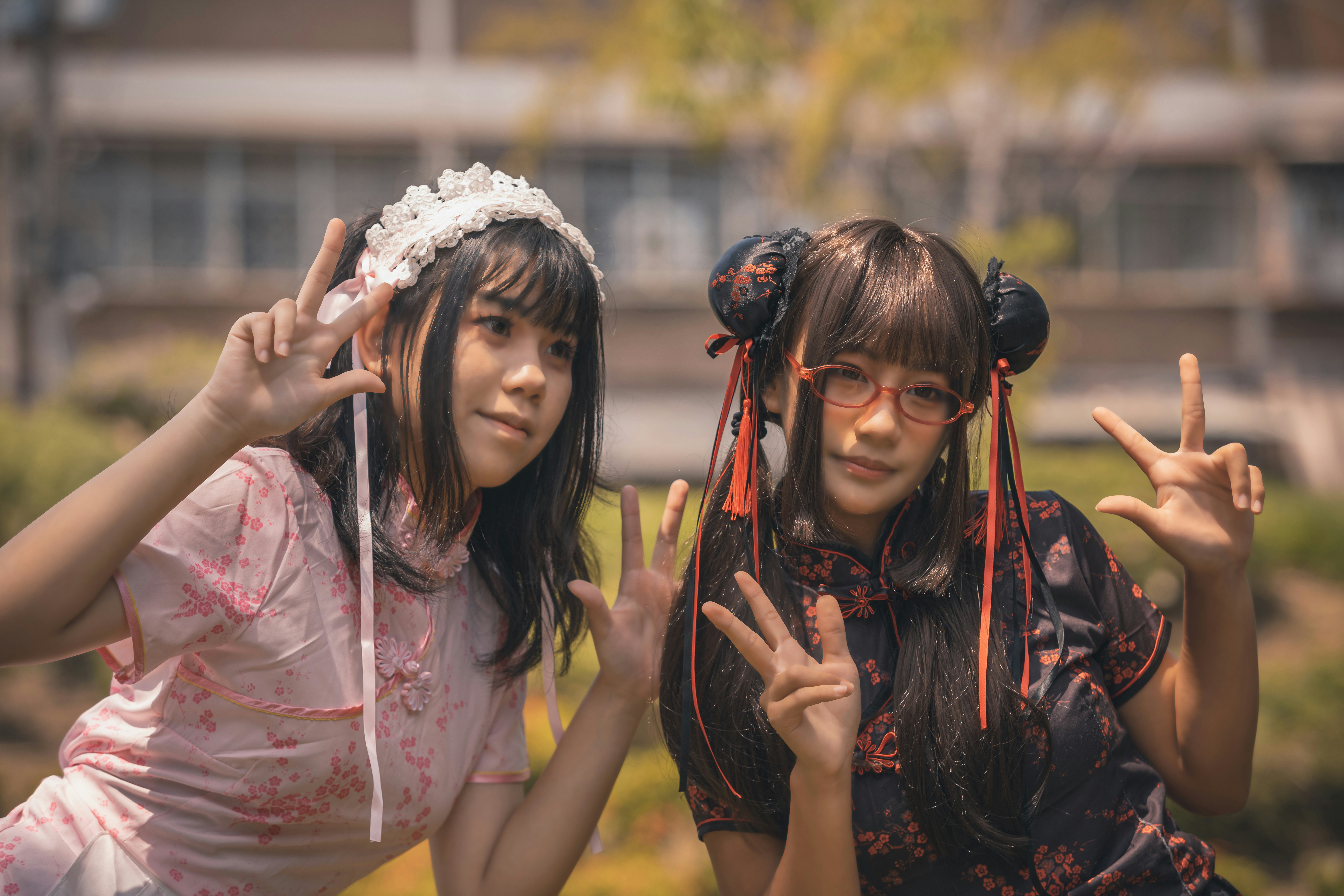 Two women pose for a photo outdoors.