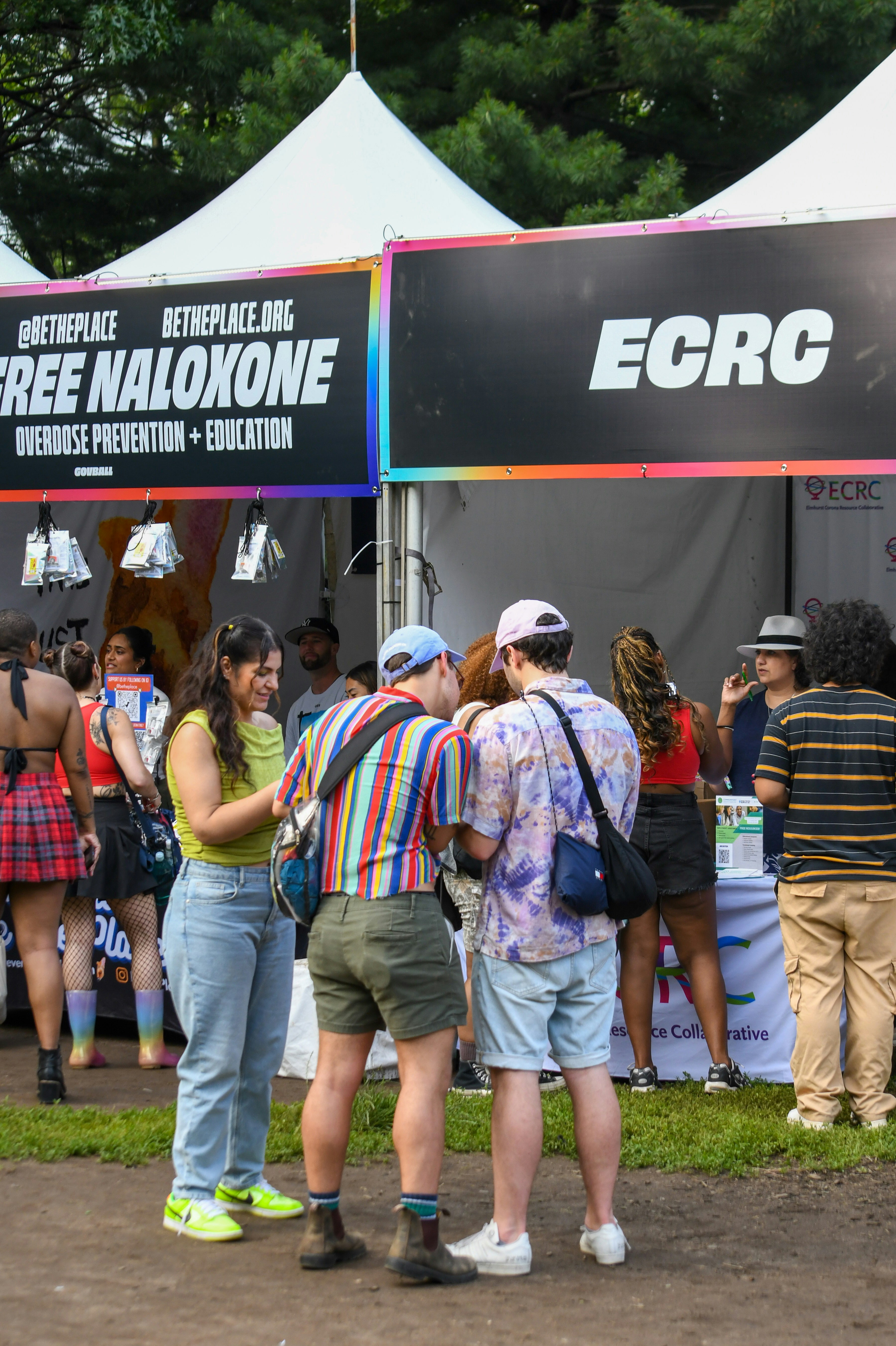 People visit outreach tents for overdose prevention and education.