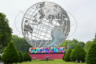 The unisphere sculpture stands in a park setting.